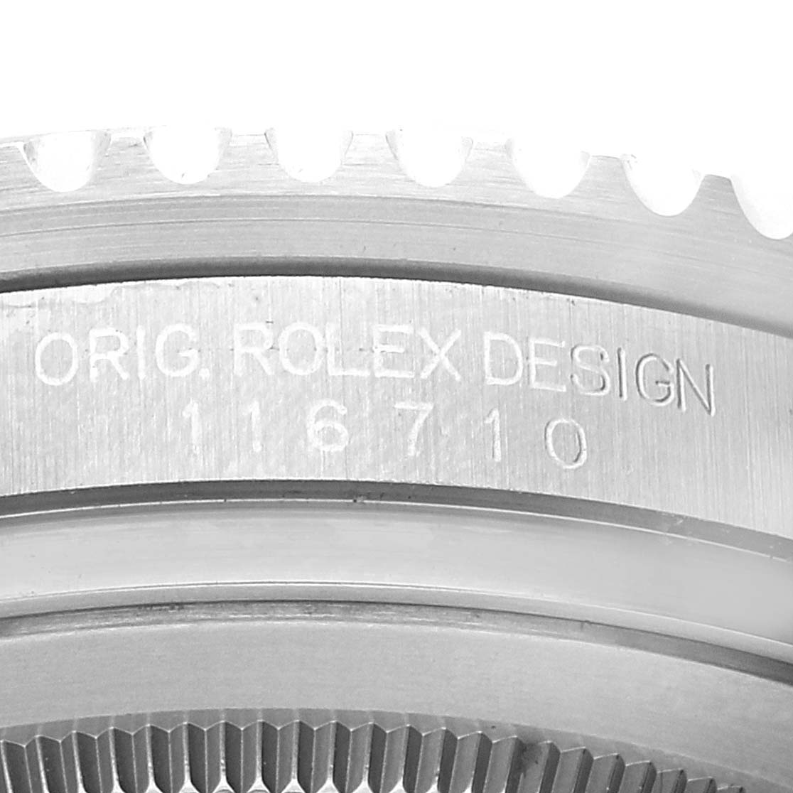 This image shows a close-up view of the engraved bezel of a Rolex GMT-Master 116710 Men's Stainless Steel Black Dial 116710 Men's Stainless Steel Black Dial watch.