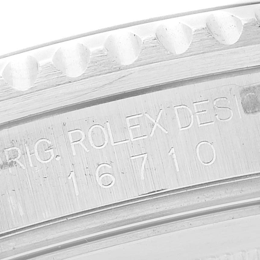 This image shows a close-up of the engraved serial number and model details on the case of a Rolex GMT-Master 16710 Men's Stainless Steel Black Dial 16710 Men's Stainless Steel Black Dial watch.