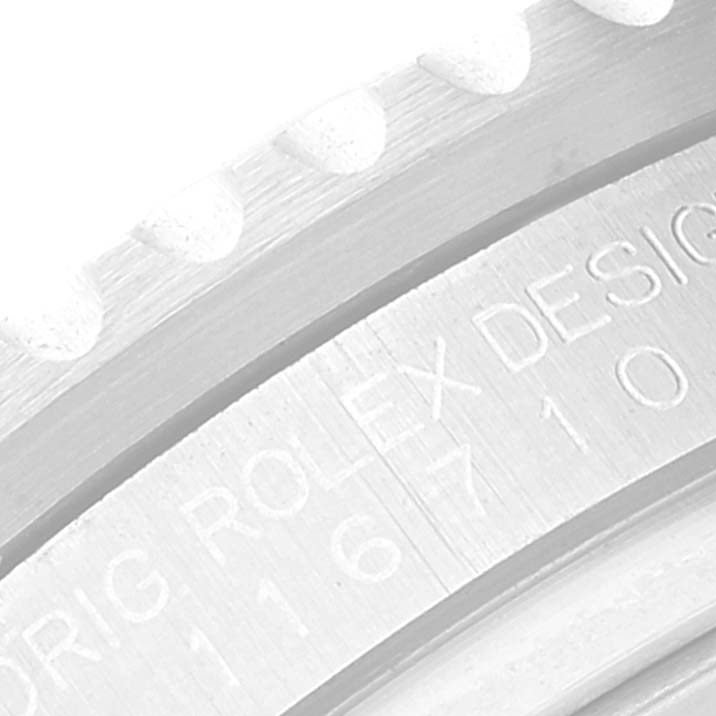 The image shows a close-up of the engraved bezel of a Rolex GMT-Master 116710 Men's Stainless Steel Black Dial 116710 Men's Stainless Steel Black Dial watch, highlighting part of the model number and the text "ORIG ROLEX DESIGN."