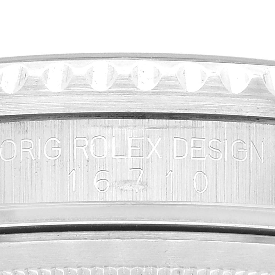 The image shows a close-up of the engraved caseback, bezel, and reference number ("16710") of a Rolex GMT-Master 16710 Men
s Stainless Steel Black Dial 16710 Men
s Stainless Steel Black Dial watch.