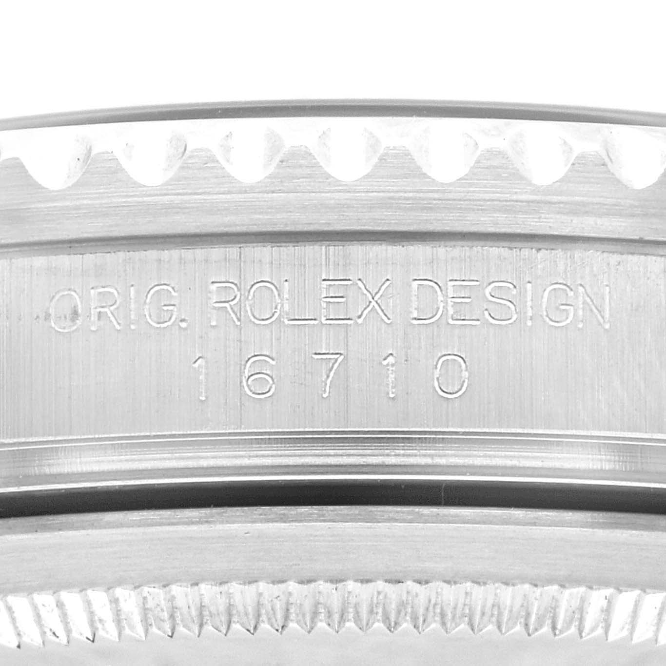 The image shows a close-up of the engraved model number and bezel teeth of a Rolex GMT-Master 16710 Men
s Stainless Steel Black Dial 16710 Men
s Stainless Steel Black Dial with the design number 16710.