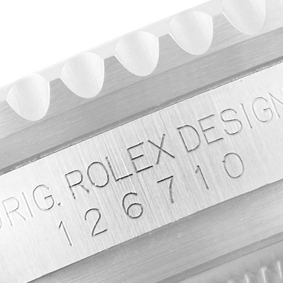 This close-up image shows the engraved model number on the side of the casing of a Rolex GMT-Master 126710 Men
s Stainless Steel Black Dial 126710 Men
s Stainless Steel Black Dial.