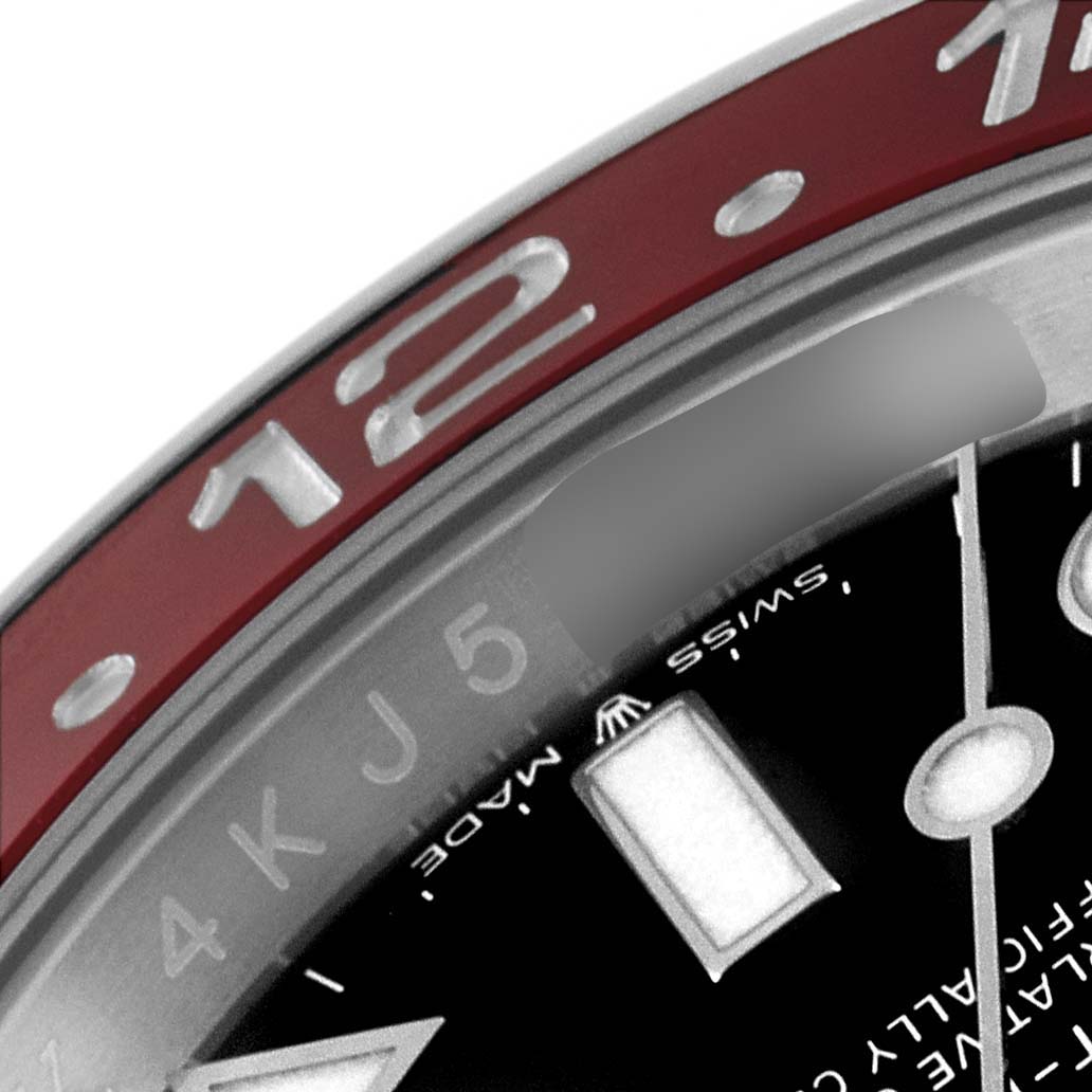 The image shows a close-up of the bezel and partially the dial of the Rolex GMT-Master 126710 Men
s Stainless Steel Black Dial 126710 Men
s Stainless Steel Black Dial watch, highlighting the 12 o
clock position.