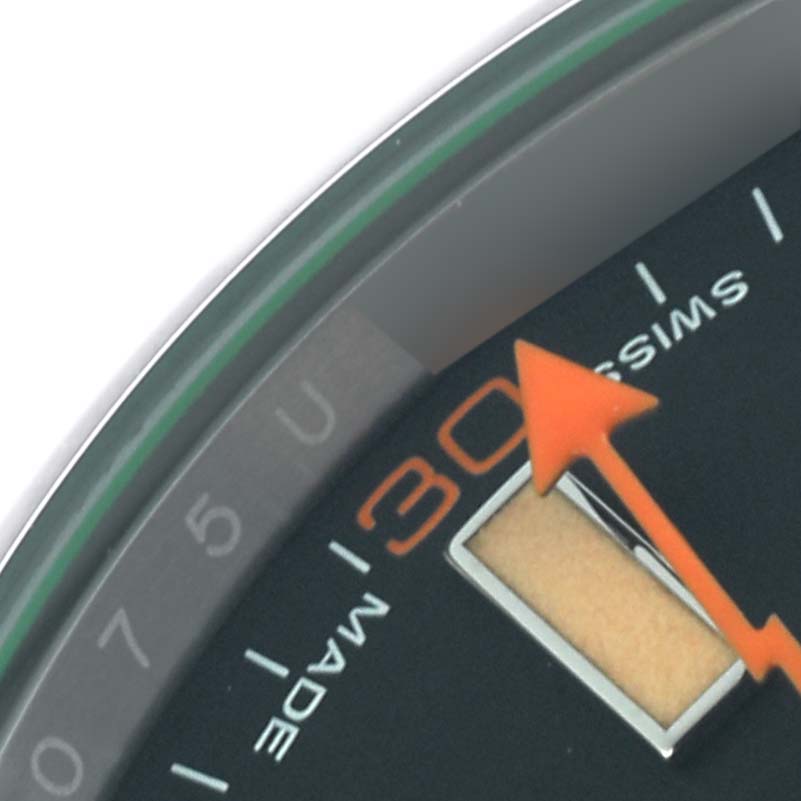 The image shows a close-up of the Rolex Milgauss 116400GV Men's Stainless Steel Black Dial 116400GV Men's Stainless Steel Black Dial watch face, focusing on the minute markers, orange seconds hand, and part of the dial.