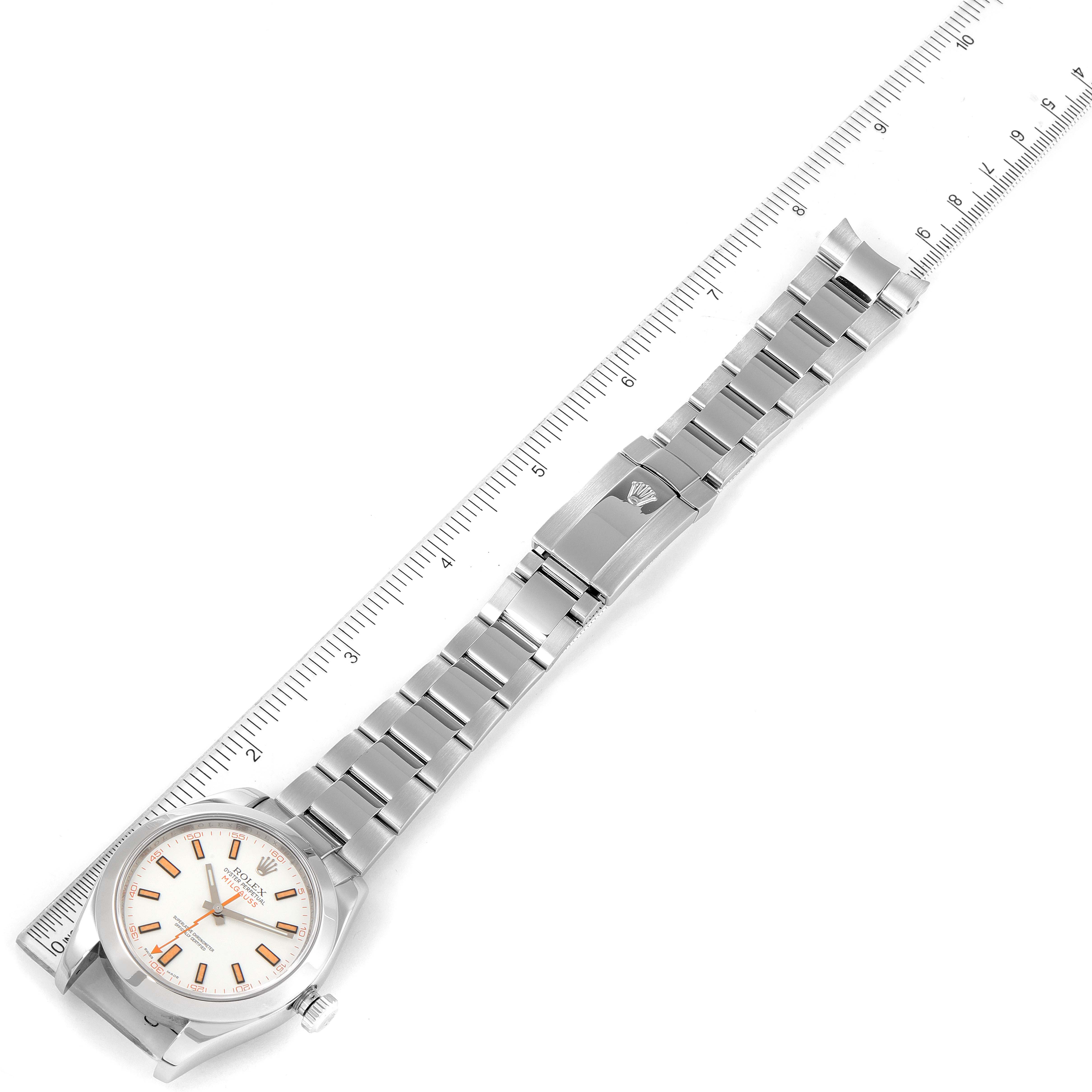 The image shows the full length of a Rolex Milgauss 116400V Men's Stainless Steel White Dial 116400V Men's Stainless Steel White Dial watch laying flat, including the face, bracelet, and clasp, next to a ruler.