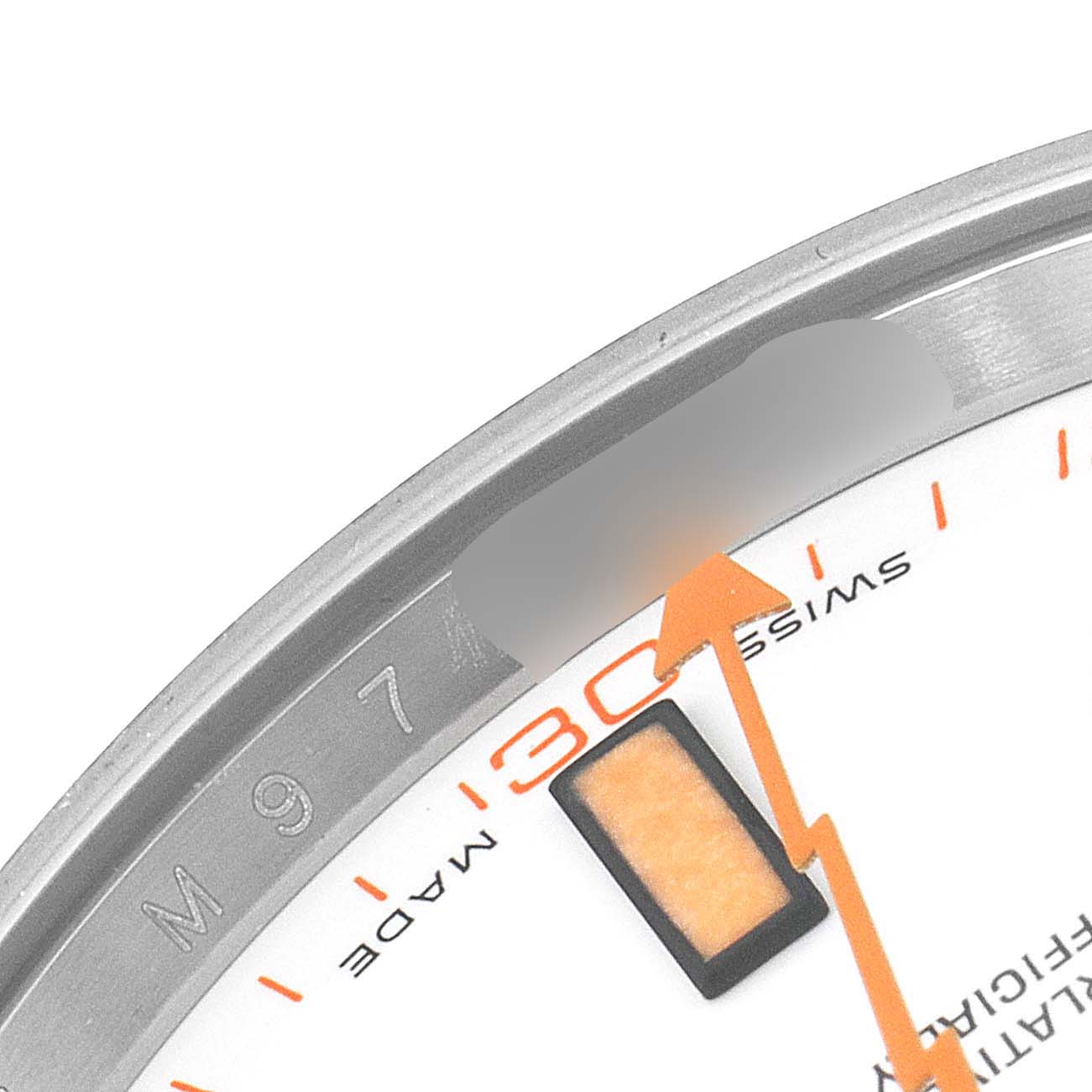 This image shows a close-up of the orange minute hand and partial dial markings of a Rolex Milgauss 116400V Men's Stainless Steel White Dial 116400V Men's Stainless Steel White Dial watch at an angled perspective.