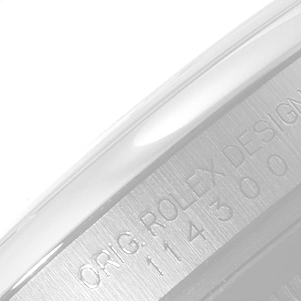 This image shows a close-up of the inner bezel of a Rolex Oyster Perpetual 114300 Men's Stainless Steel Grey Dial 114300 Men's Stainless Steel Grey Dial watch, displaying the engraved model details.