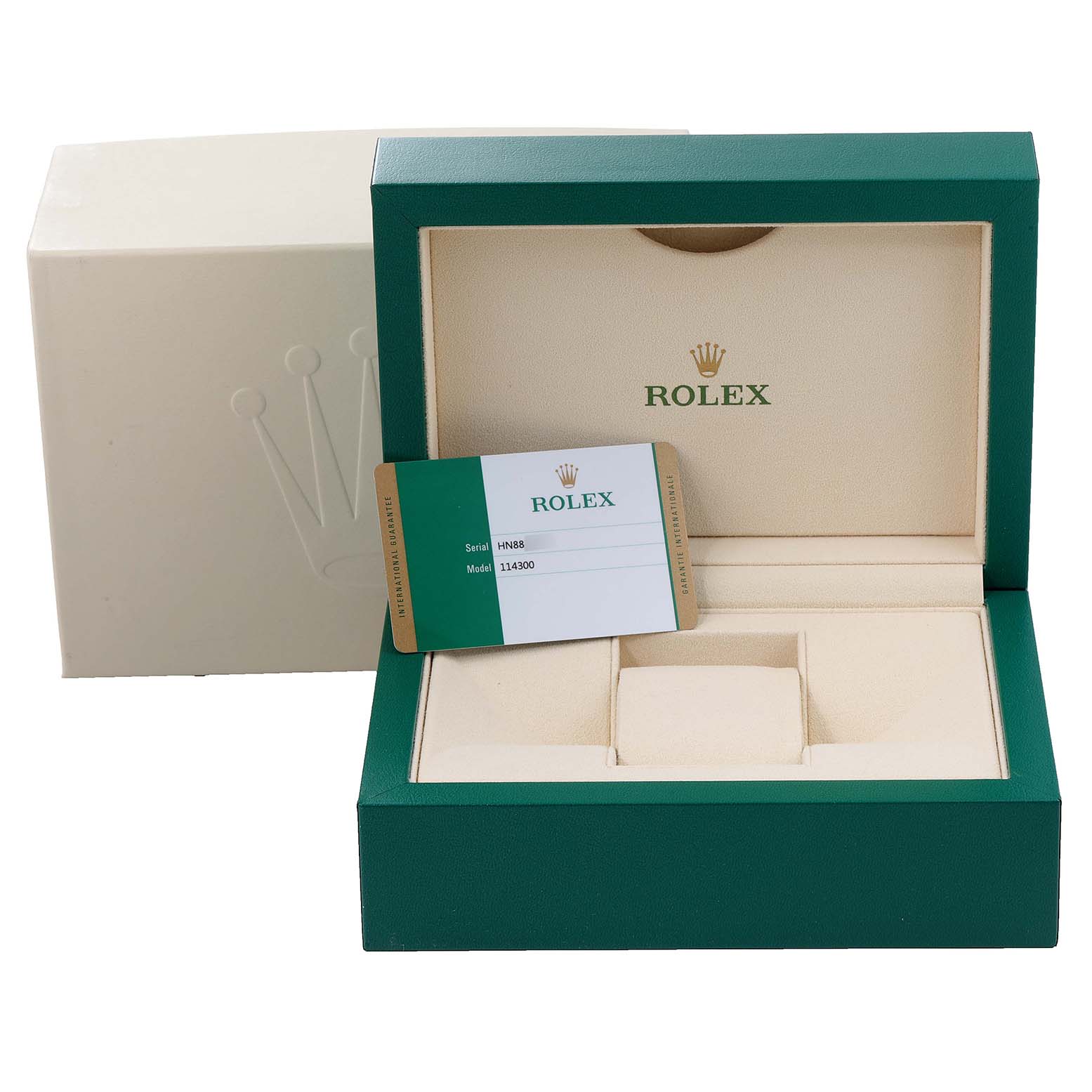 The image shows an open green Rolex box for an Oyster Perpetual model, displaying the inner cushion and a serial/model card.