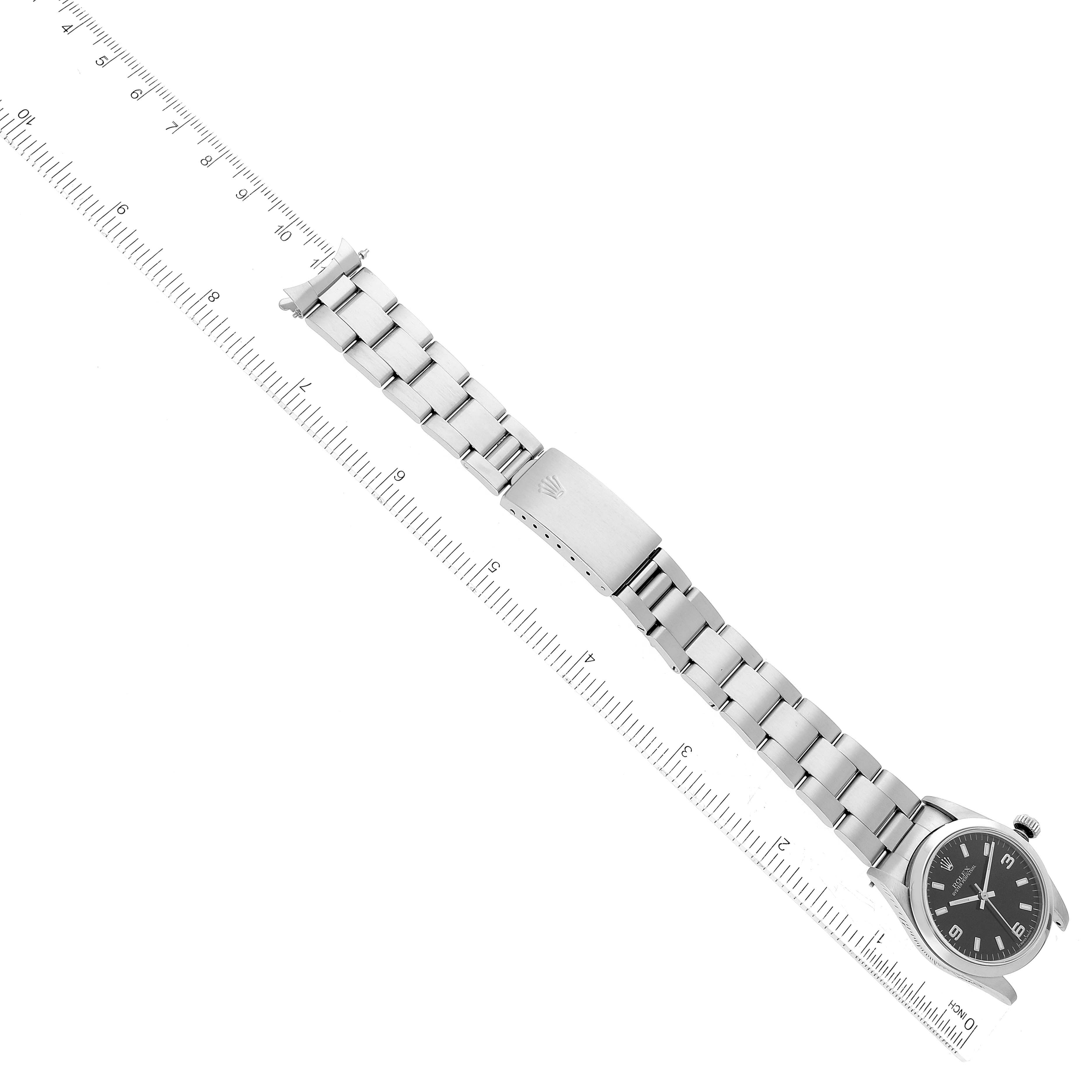 This image shows the Mid-Size Rolex watch at a top-down angle, displaying the watch face, bezel, bracelet, and clasp.