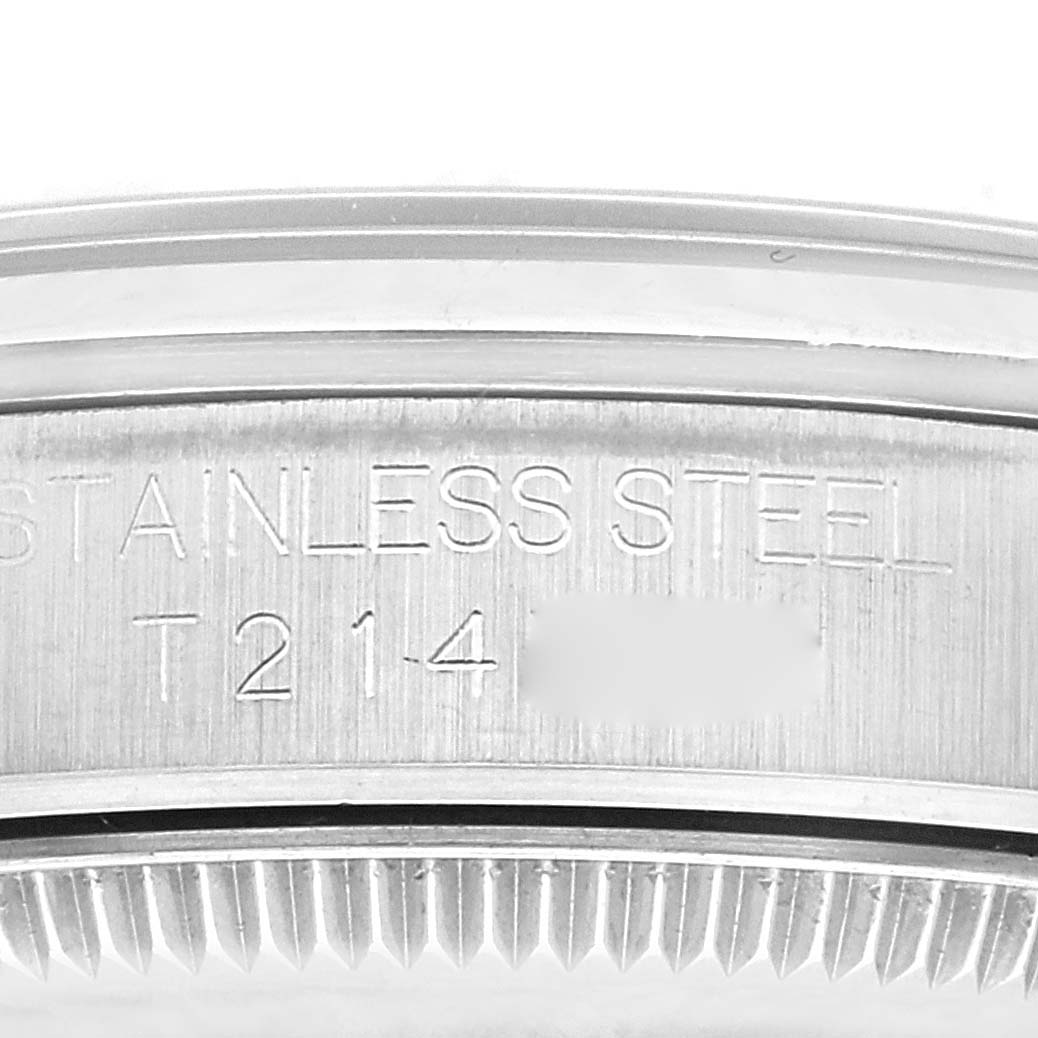 This image shows a close-up of the engraved stainless steel casing and part of the bezel of a Mid-Size Rolex watch.
