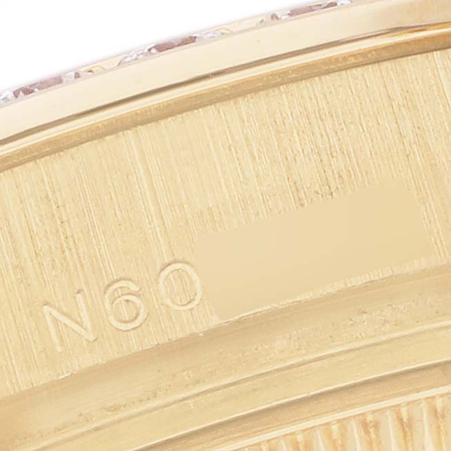The image shows an angled close-up of the bezel edge and serial number engraving on a Rolex Pearlmaster 69298 Women's Yellow Gold Champagne Dial 69298 Women's Yellow Gold Champagne Dial watch.
