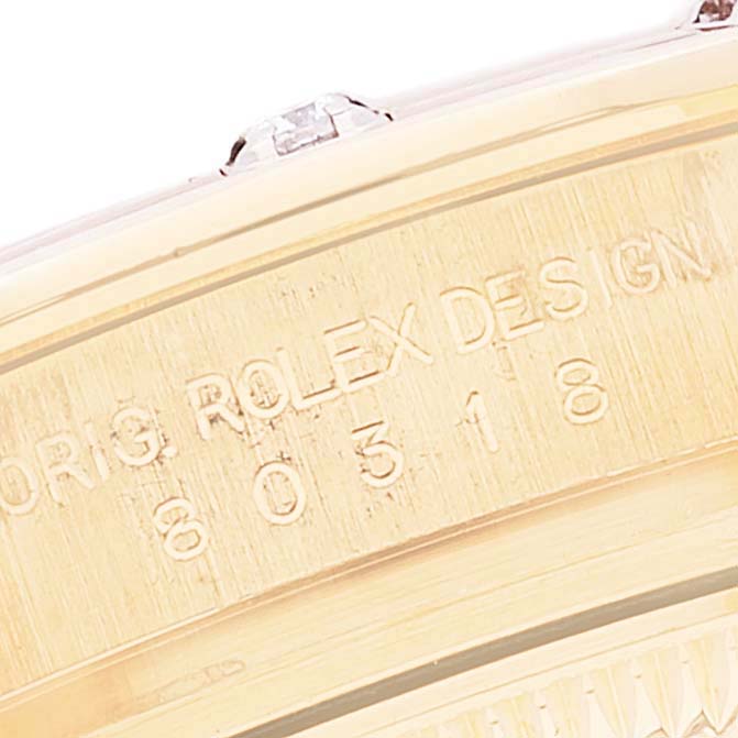 The image shows a close-up of the side of a Rolex Pearlmaster 80318 Women's Yellow Gold White Dial 80318 Women's Yellow Gold White Dial watch, highlighting the engraved design and serial numbers.