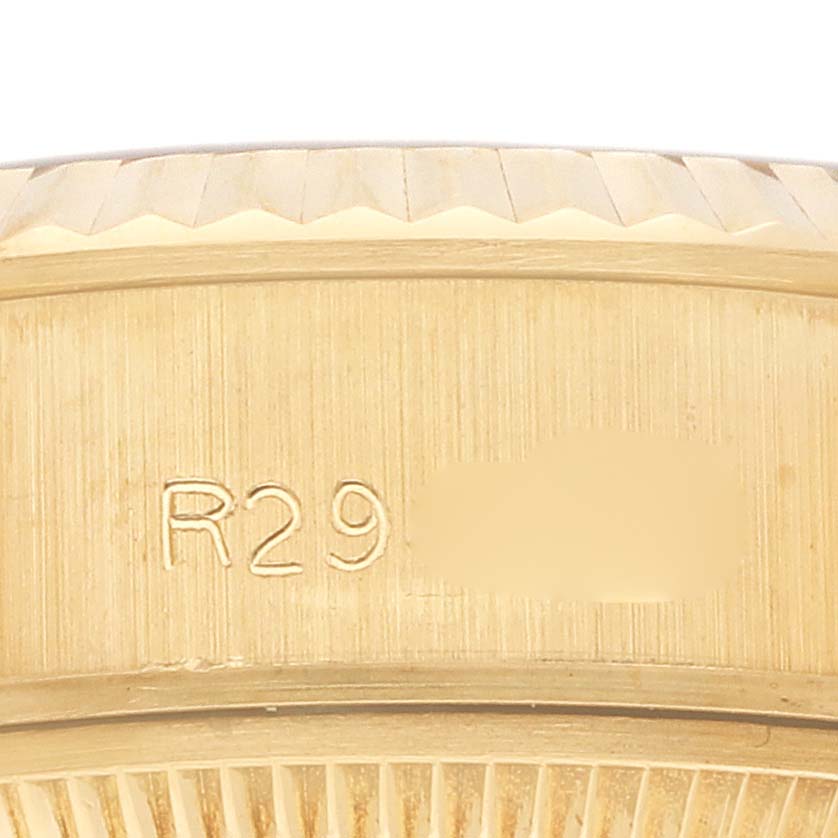 The image shows a close-up of the side engraving on a Rolex President 69178 Women's Yellow Gold Champagne Dial 69178 Women's Yellow Gold Champagne Dial watch case.