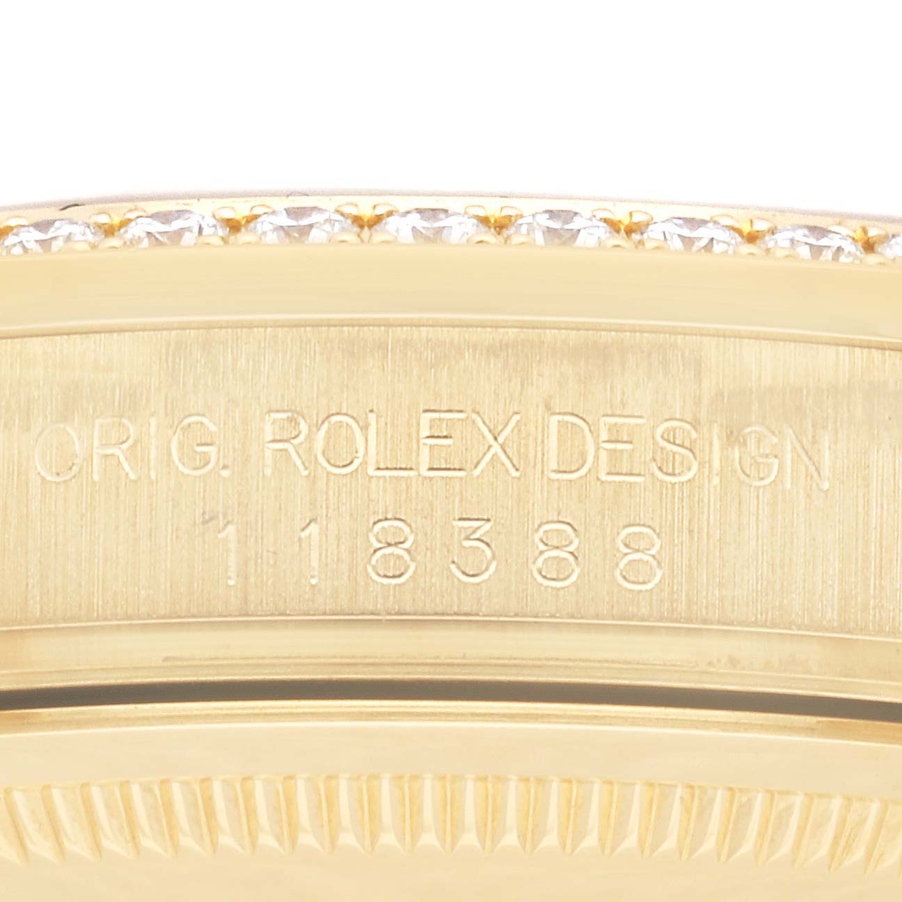 This close-up image shows the side of a Rolex President 118388 Men
s Yellow Gold Champagne Dial 118388 Men
s Yellow Gold Champagne Dial model featuring its engraved design and reference number.