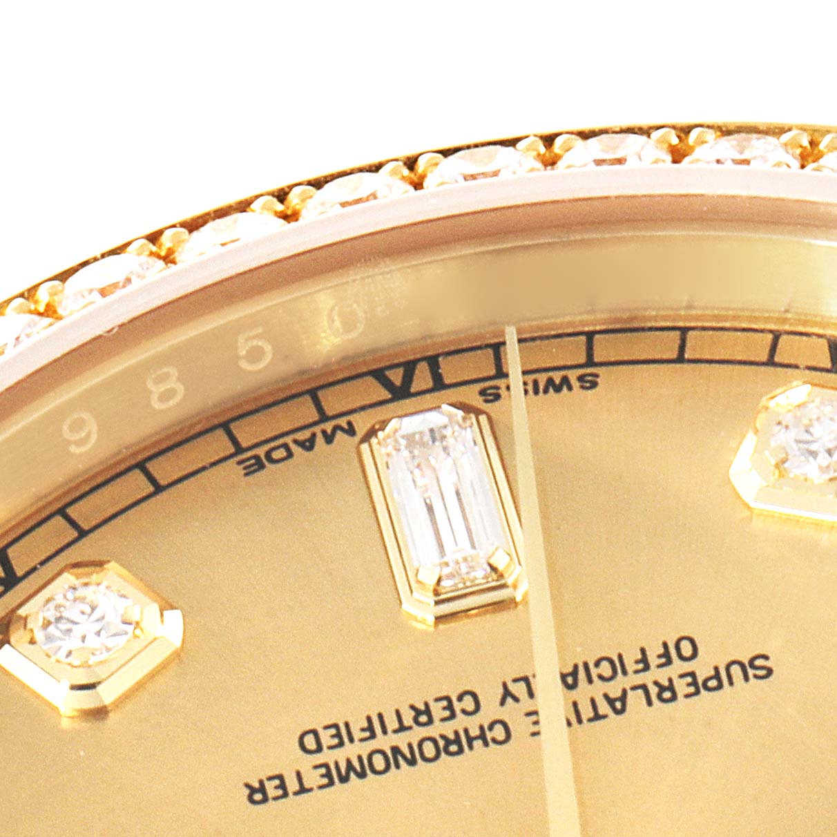 This close-up image of a Rolex President 118388 Men
s Yellow Gold Champagne Dial 118388 Men
s Yellow Gold Champagne Dial model shows the bezel, diamonds, and part of the dial with text.