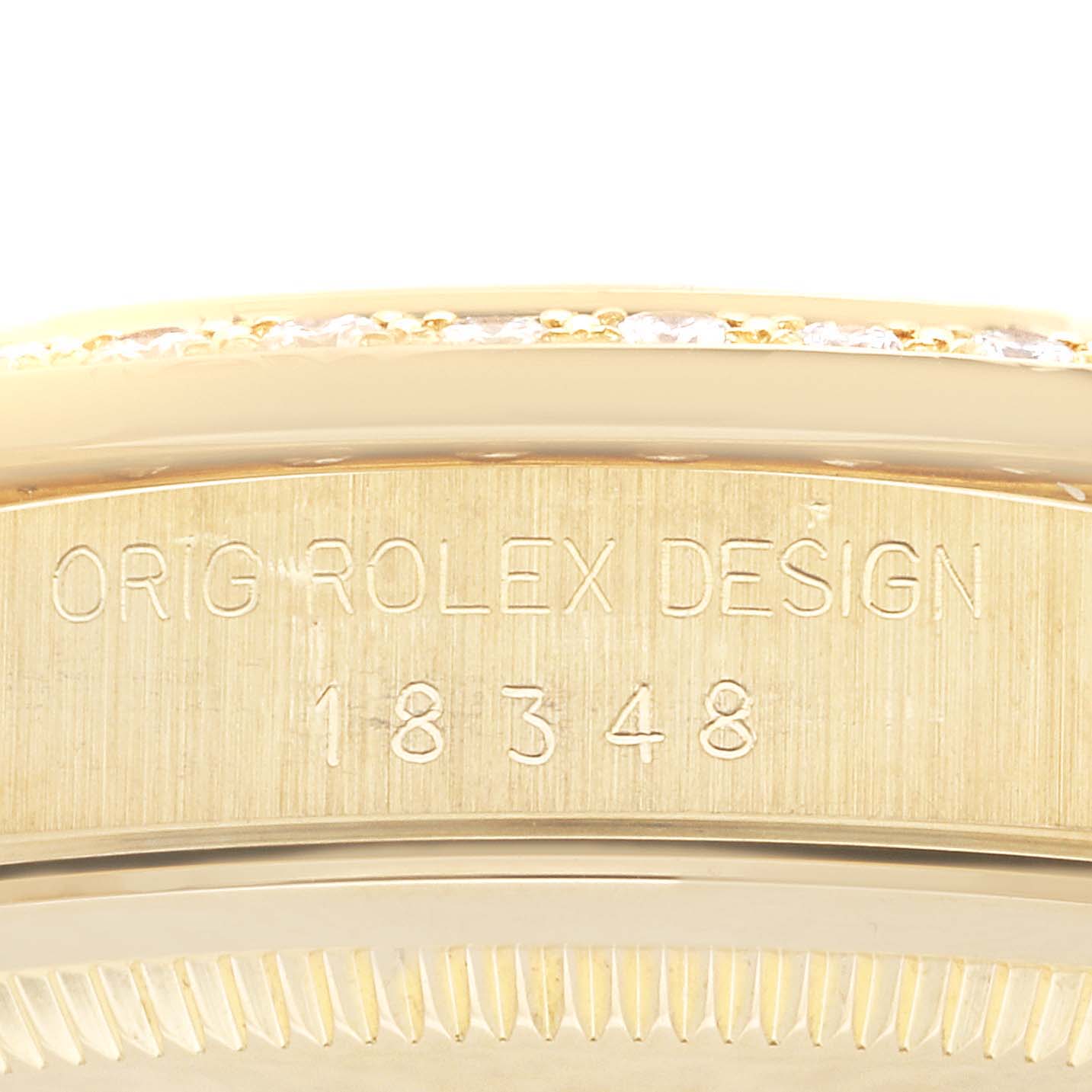 This close-up image shows the engraved side of the gold Rolex President 18348 Men's Yellow Gold Champagne Dial 18348 Men's Yellow Gold Champagne Dial watch, displaying "ORIG ROLEX DESIGN 18348."