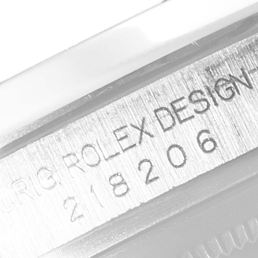 This close-up image shows the engraved model number and "Rolex Design" on the case of a Rolex President 218206 Men's Platinum Blue Dial 218206 Men's Platinum Blue Dial watch.