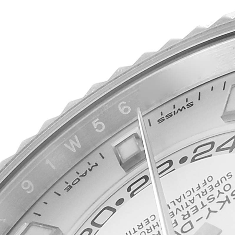The image shows a close-up angle of the dial and bezel of a Rolex Sky-Dweller 326934 Men's Stainless Steel White Dial 326934 Men's Stainless Steel White Dial watch, highlighting the numerals and part of the hand.