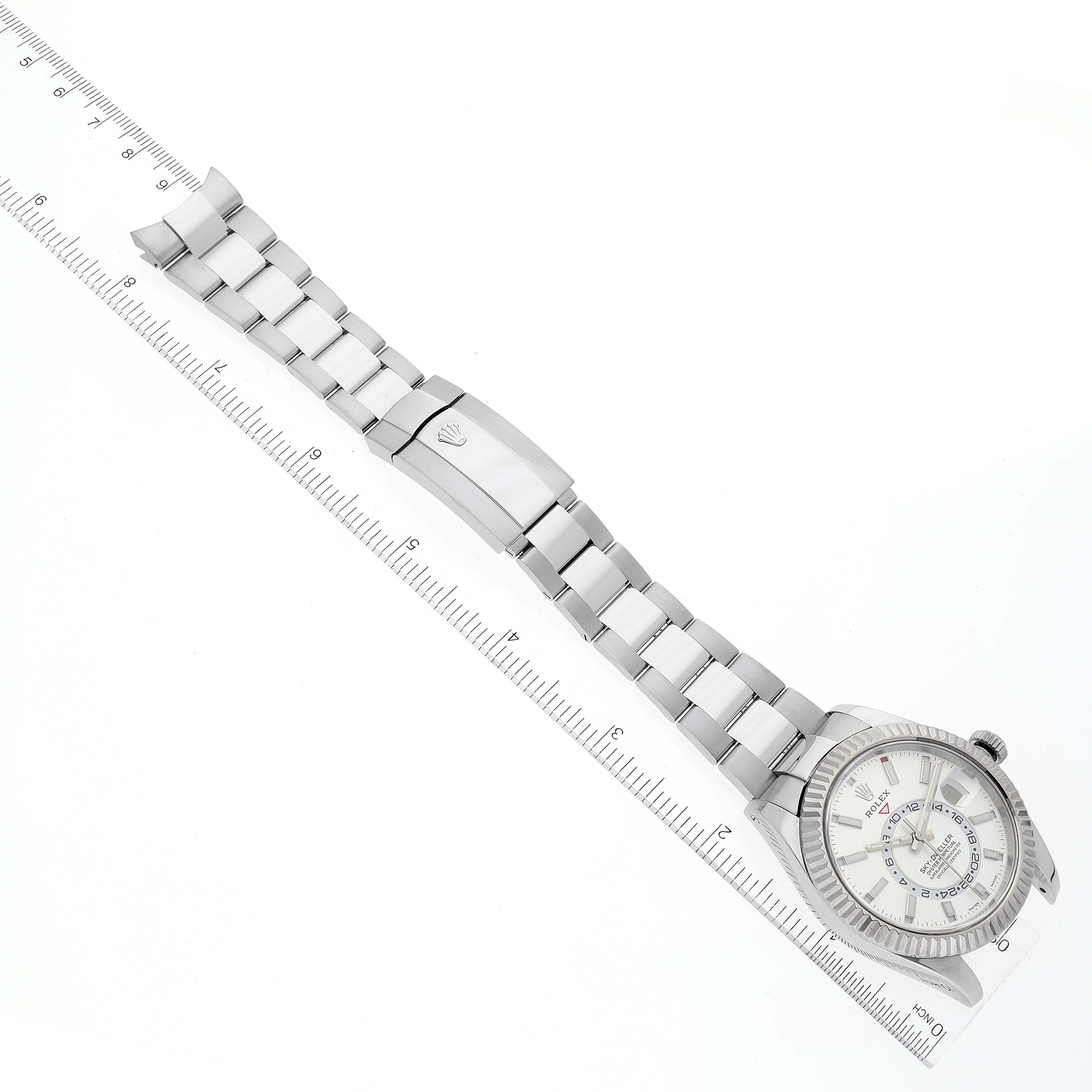 The Rolex Sky-Dweller 326934 Men's Stainless Steel White Dial 326934 Men's Stainless Steel White Dial watch is shown from a top-down angle, displaying the full face, bracelet, and clasp.