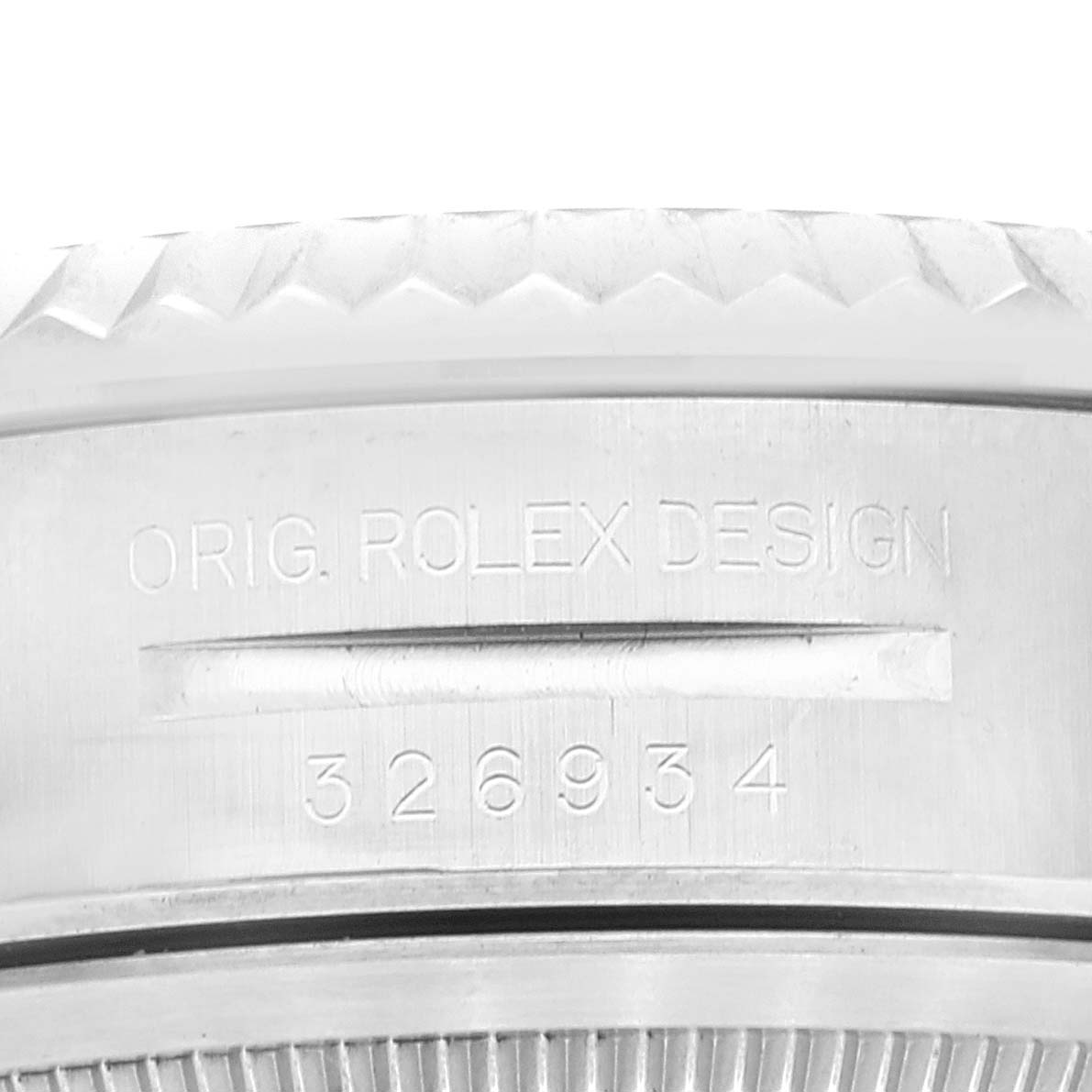 The image shows a close-up of the outer casing of a Rolex Sky-Dweller 326934 Men's Stainless Steel White Dial 326934 Men's Stainless Steel White Dial, highlighting the model number 326934 and engraving.