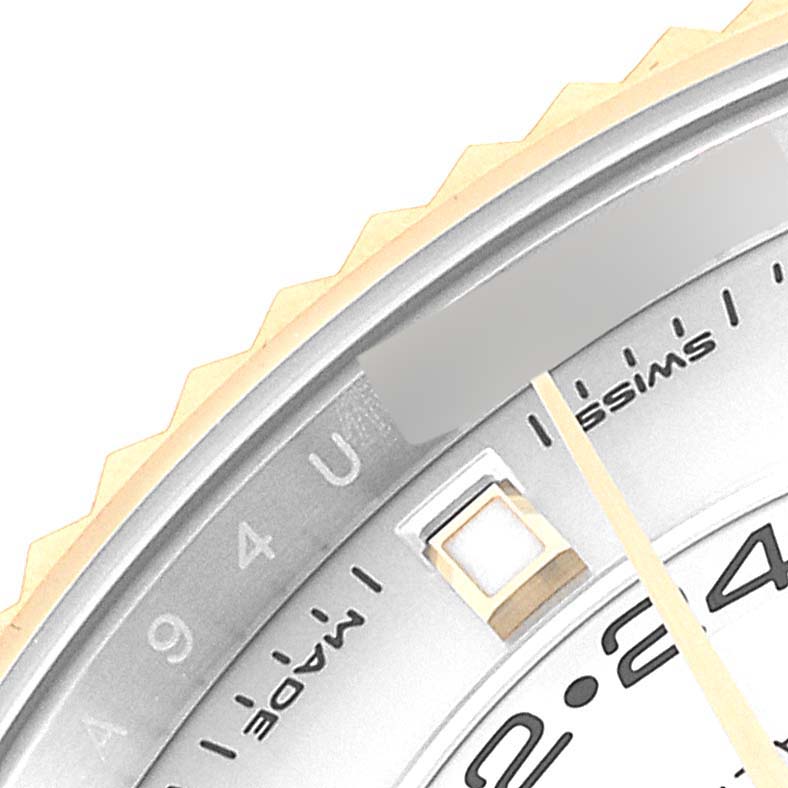 This close-up of the Rolex Sky-Dweller 326933 Men's Steel and Gold (two tone) White Dial 326933 Men's Steel and Gold (two tone) White Dial shows the bezel and part of the dial displaying numbers and markings.