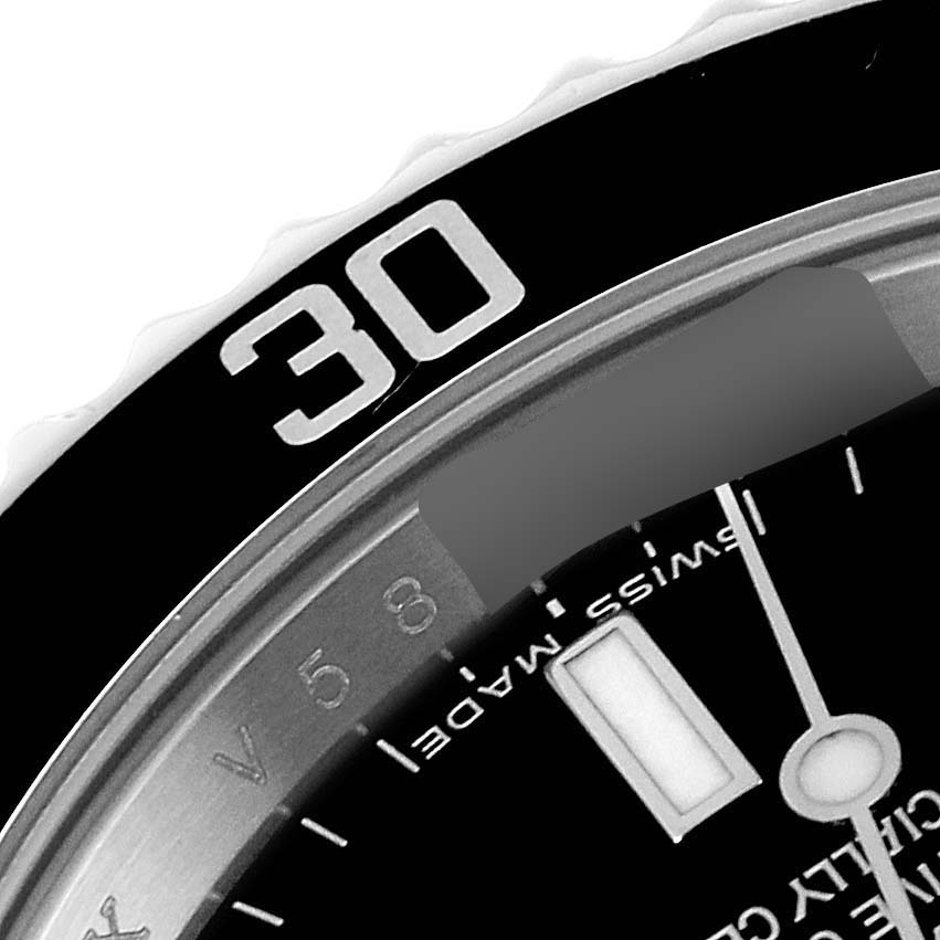 This image shows a close-up of the bezel and part of the dial on a Rolex Submariner 14060M Men's Stainless Steel Black Dial 14060M Men's Stainless Steel Black Dial watch.