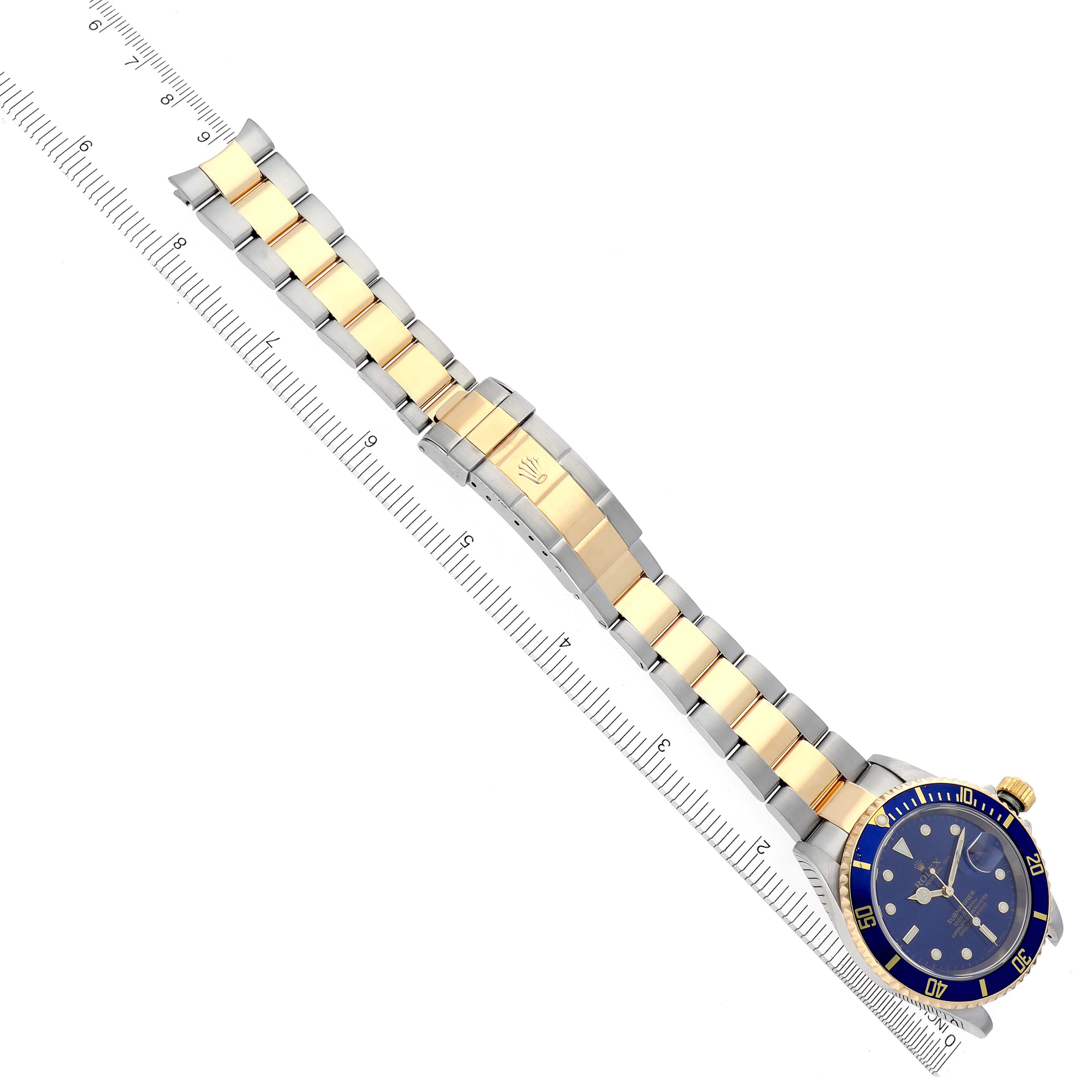 The Rolex Submariner 16613 Men's Steel and Gold (two tone) Blue Dial 16613 Men's Steel and Gold (two tone) Blue Dial watch is displayed at an overhead angle, showing its bracelet, clasp, and blue dial.