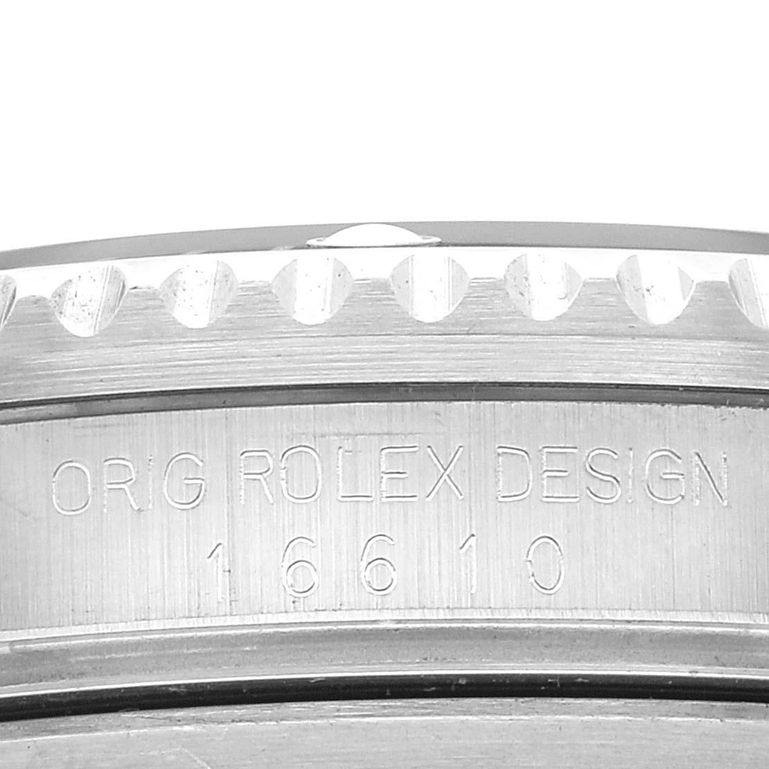 This image shows a close-up of the engraved case side of a Rolex Submariner 16610 Men's Stainless Steel Black Dial 16610 Men's Stainless Steel Black Dial, displaying the model number 16610 and the text "ORIG ROLEX DESIGN."