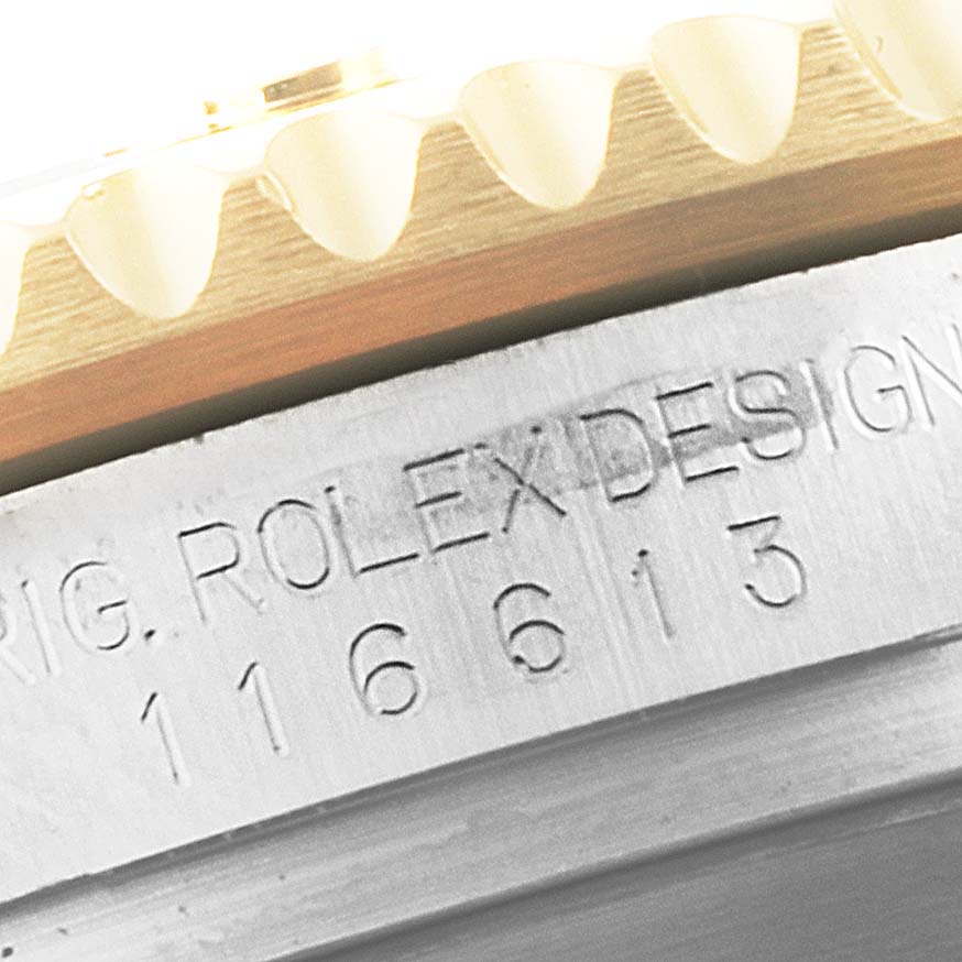 The image shows the engraved bezel and case side of a Rolex Submariner 116613 Men's Steel and Gold (two tone) Black Dial 116613 Men's Steel and Gold (two tone) Black Dial model.