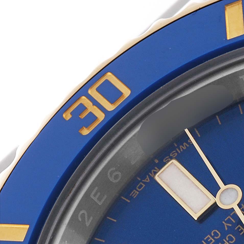 The image shows a close-up angle of the bezel and dial of a Rolex Submariner 116613 Men
s Steel and Gold (two tone) Blue Dial 116613 Men
s Steel and Gold (two tone) Blue Dial watch, highlighting the blue and gold details.