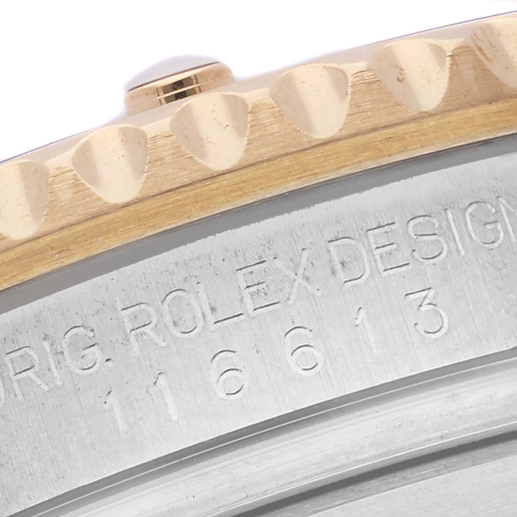The image shows a close-up of the edge and engraved serial number of a Rolex Submariner 116613LB Men
s Steel and Gold (two tone) Blue Dial 116613LB Men
s Steel and Gold (two tone) Blue Dial model.