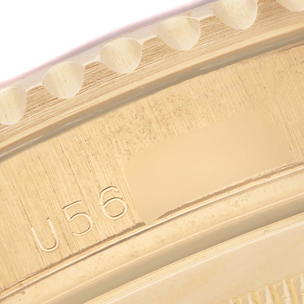 This is a close-up of the bezel and outer edge of a Rolex Yacht-Master 16628 Men's Yellow Gold White Dial 16628 Men's Yellow Gold White Dial watch, showing part of the serial number.