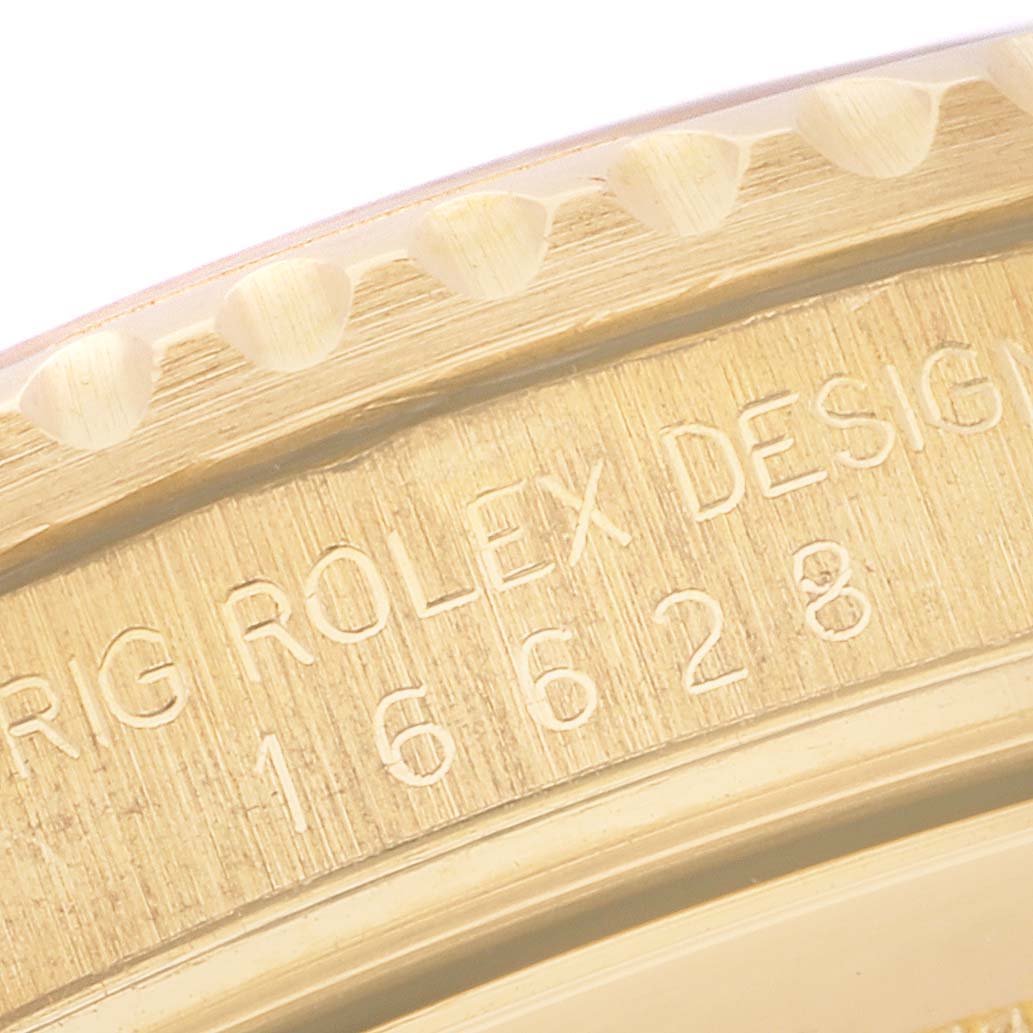 The image shows a close-up of the bezel and engraved serial number of the Rolex Yacht-Master 16628 Men's Yellow Gold White Dial 16628 Men's Yellow Gold White Dial watch.
