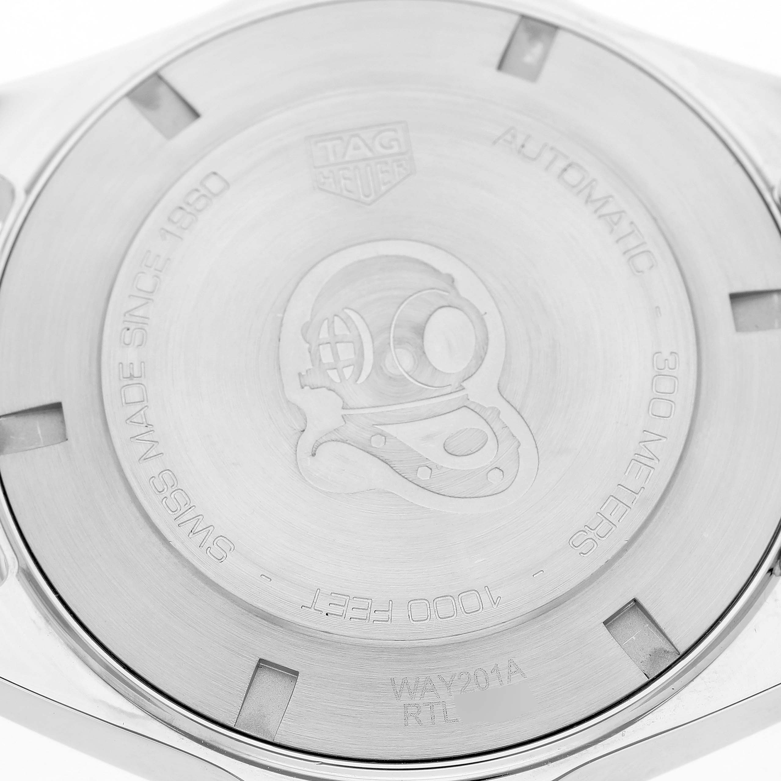 The image shows the back case of a Tag Heuer Aquaracer WAY201A Men's Stainless Steel Black Dial watch, featuring a diver helmet engraving and specifications.