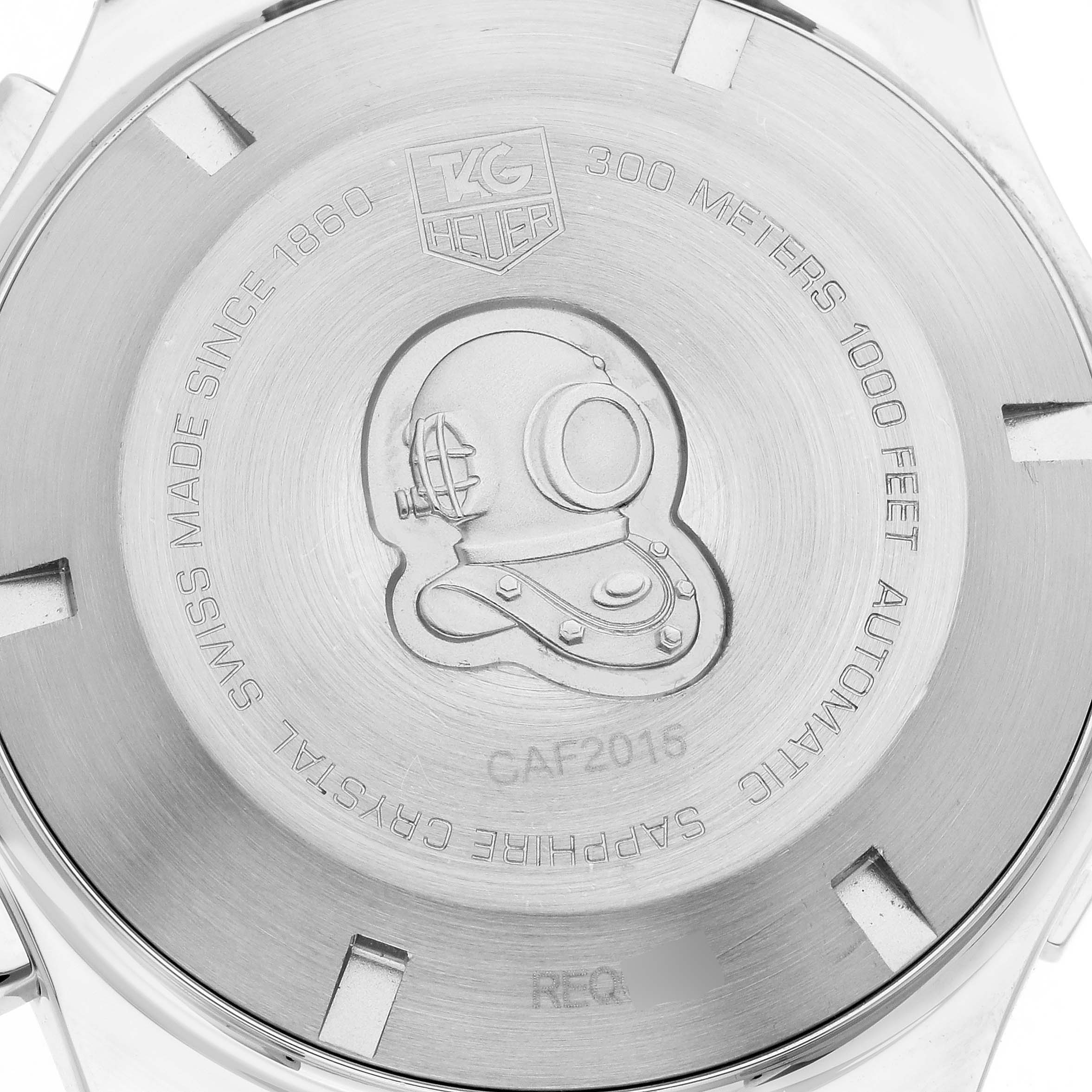 The image shows the back of a Tag Heuer Aquaracer CAF2015.BA0815 Men's Stainless Steel Silver Dial CAF2015.BA0815 Men's Stainless Steel Silver Dial watch featuring engraved details and a diving helmet design.