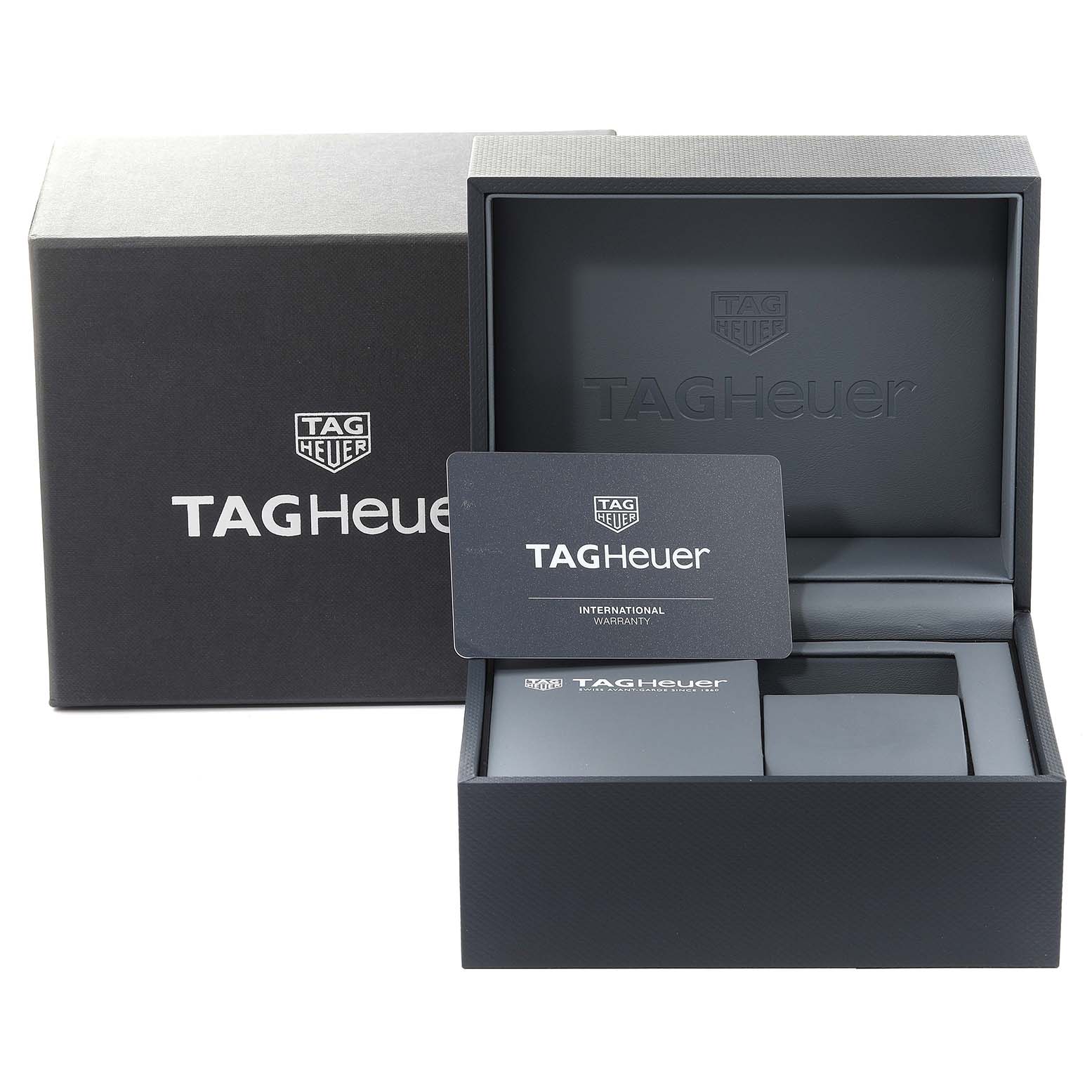 The image shows the packaging and warranty card for a Tag Heuer Carrera CBM2110 Men's Stainless Steel Black Dial CBM2110 Men's Stainless Steel Black Dial model watch, with the box partially open.