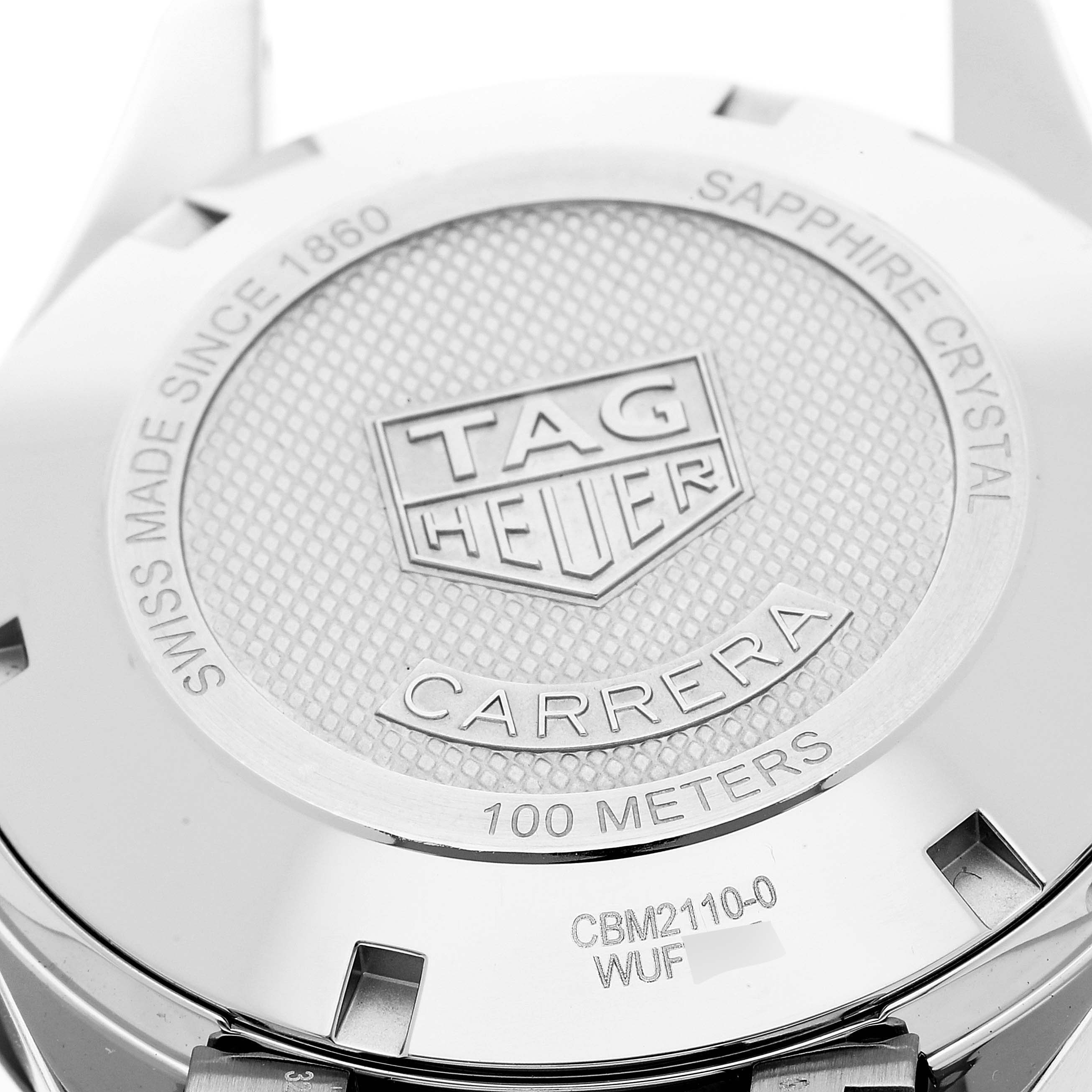 The image shows the back case of a Tag Heuer Carrera CBM2110 Men's Stainless Steel Black Dial CBM2110 Men's Stainless Steel Black Dial watch, highlighting its engravings and details.