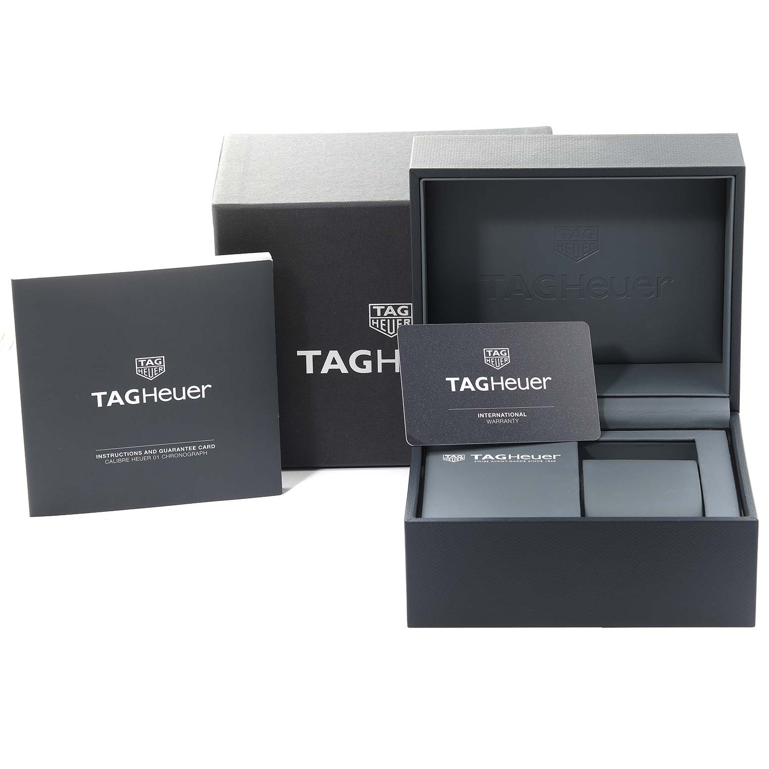 The image shows the packaging and accessories for a Tag Heuer Carrera CAR2A5A.FT6044 Men's Titanium Black Dial CAR2A5A.FT6044 Men's Titanium Black Dial watch, including the box, warranty card, and instruction manual.