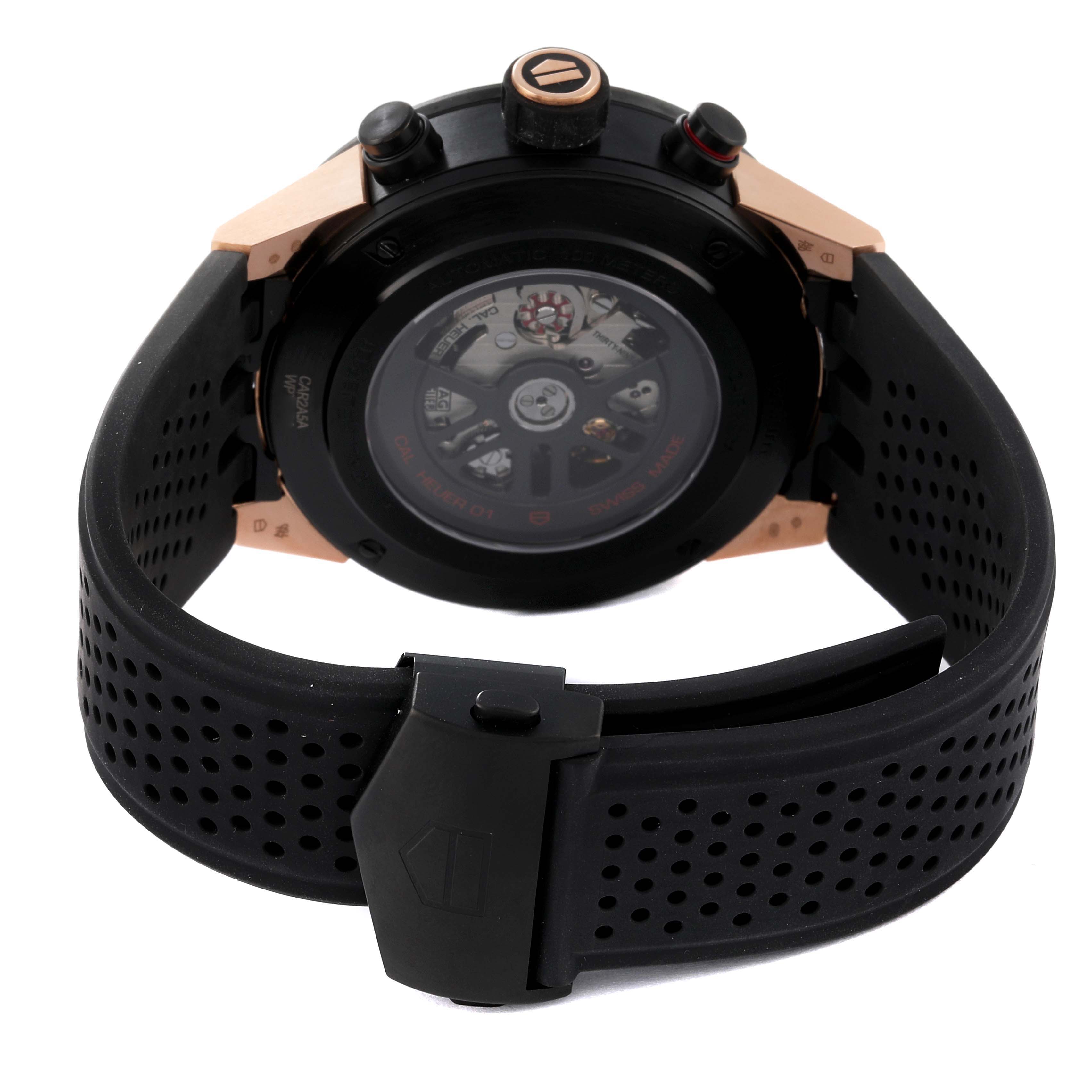 The image shows the back view of the Tag Heuer Carrera CAR2A5A.FT6044 Men's Titanium Black Dial CAR2A5A.FT6044 Men's Titanium Black Dial watch, highlighting its perforated rubber strap and exposed movement.