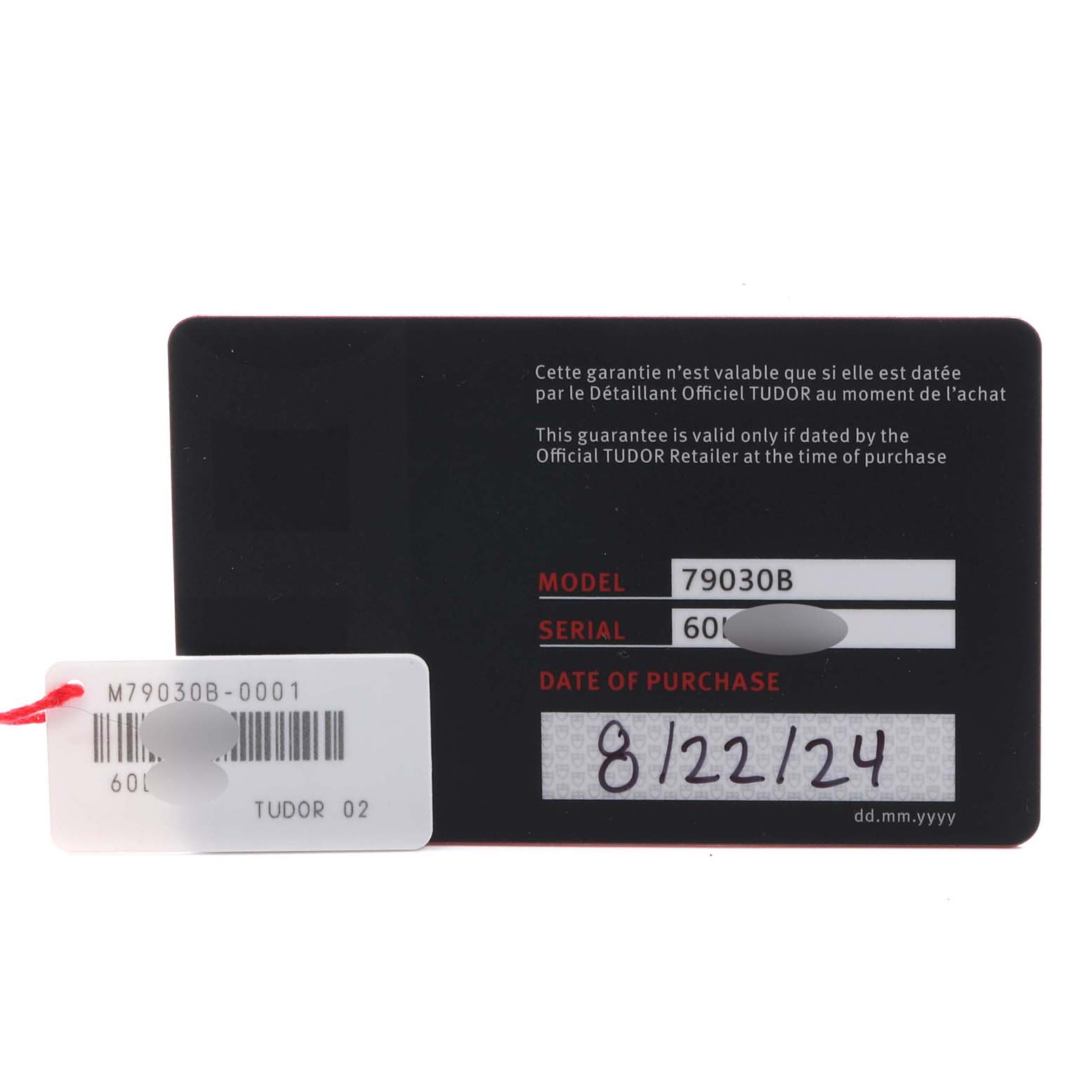 The image shows a warranty card and a tag for the Tudor Heritage Black Bay M79030B-0001 Men's Stainless Steel Blue Dial M79030B-0001 Men's Stainless Steel Blue Dial model.