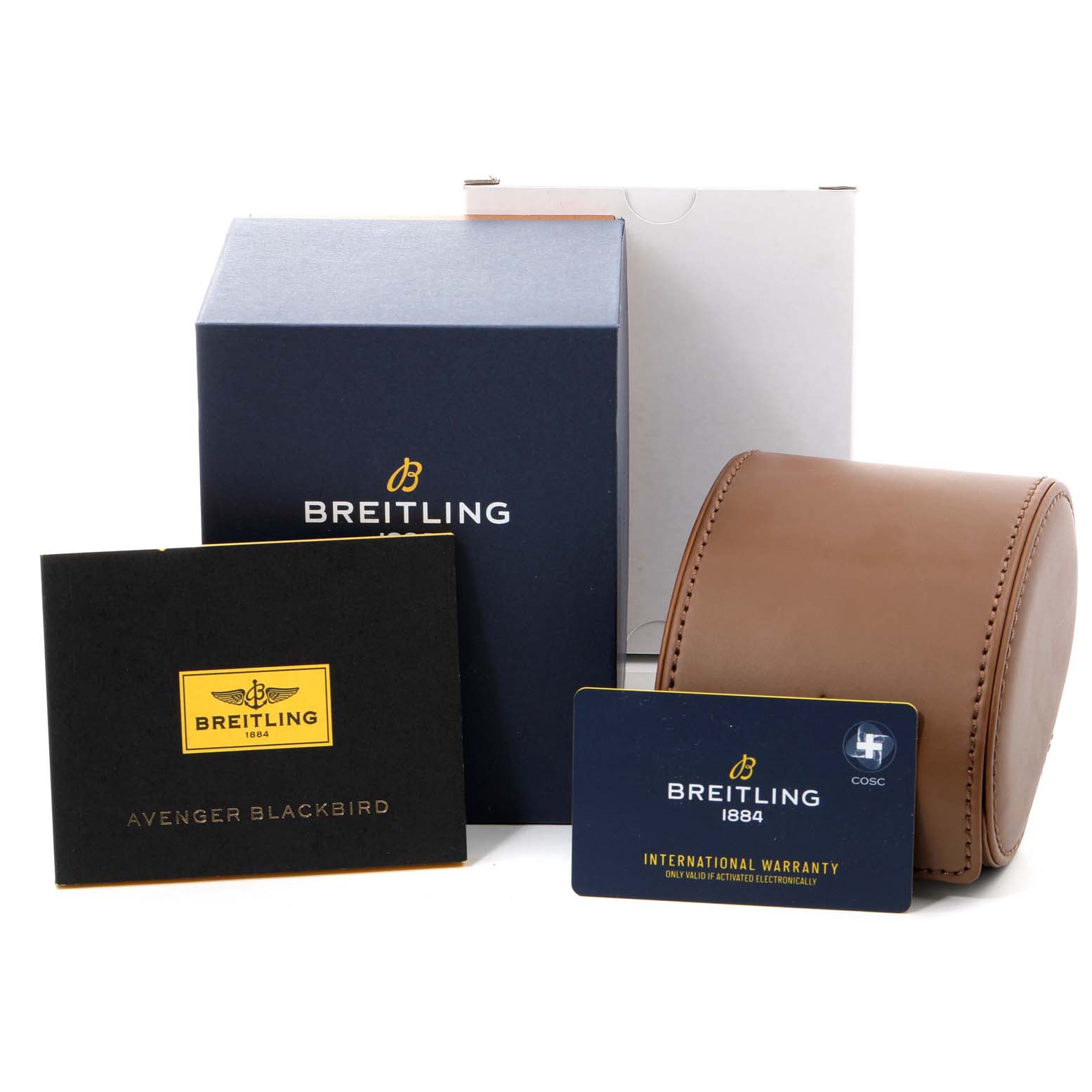 This image shows a Breitling Avenger V17310 Men's Titanium Black Dial V17310 Men's Titanium Black Dial Blackbird watch box, international warranty card, manual, and a brown leather travel case from a front angle.