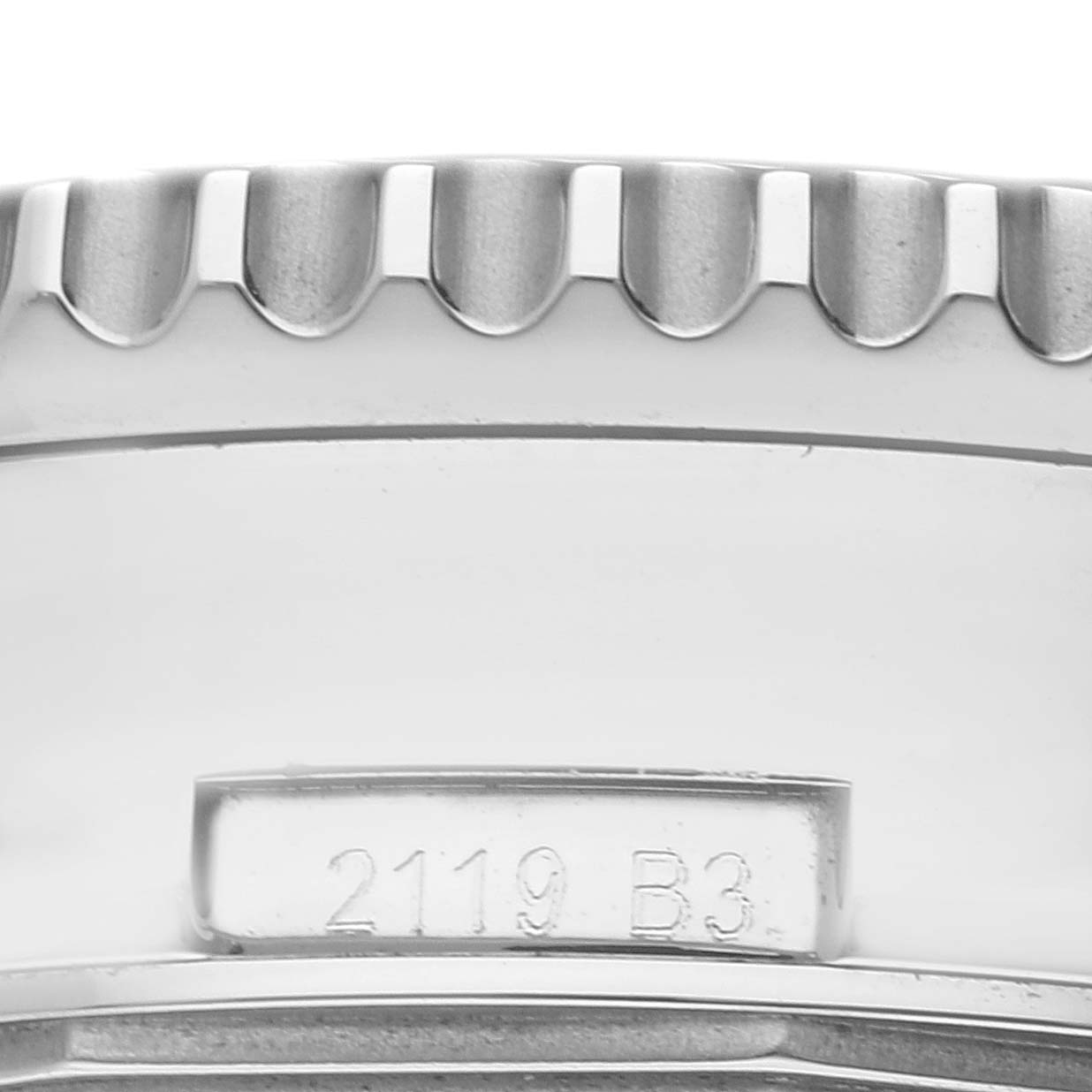 This image shows a close-up side view of the bezel and part of the case back of a Breitling Navitimer AB0127 Men's Stainless Steel Blue Dial AB0127 Men's Stainless Steel Blue Dial watch.