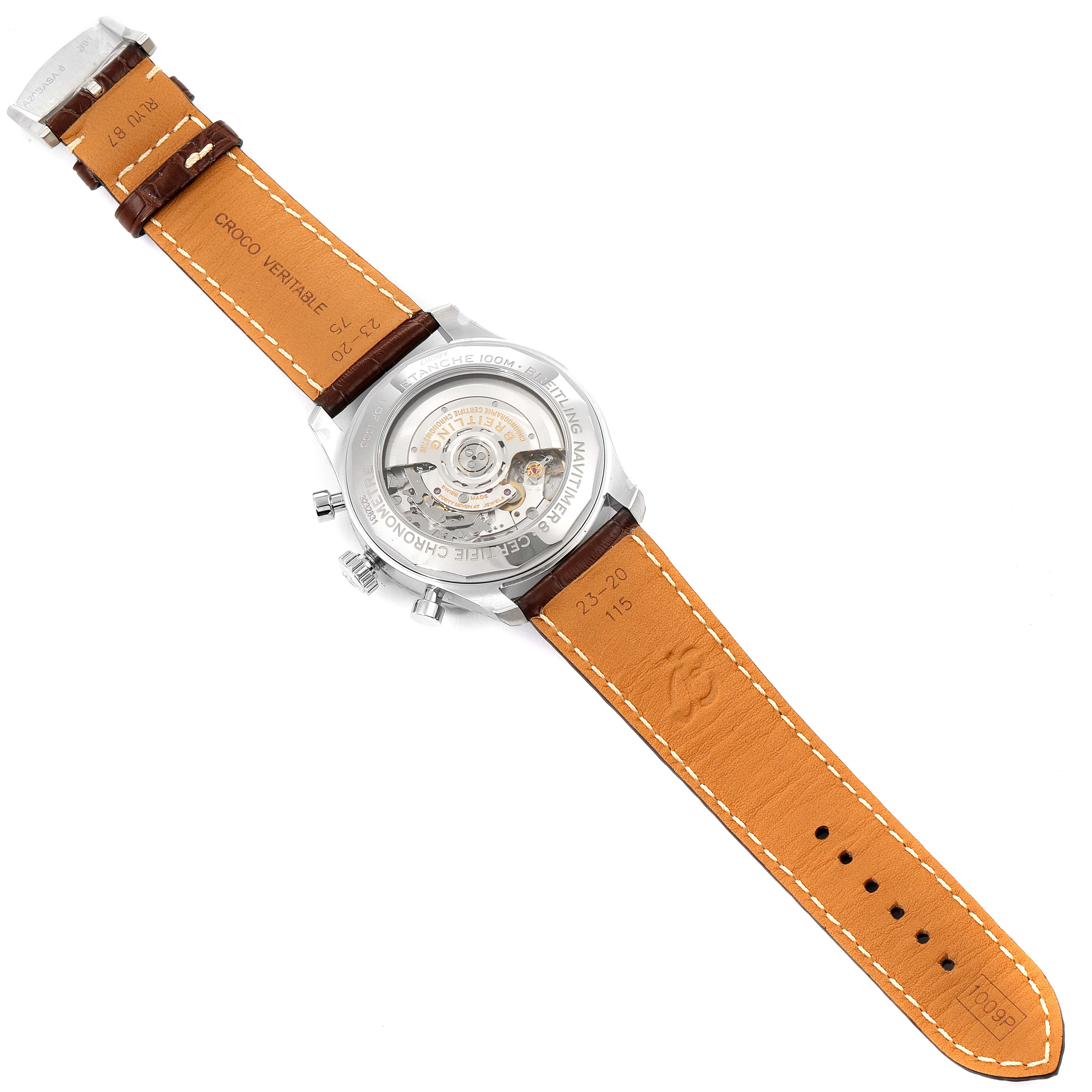 This image shows the backside of a Breitling Navitimer watch, displaying the automatic movement and brown leather strap.