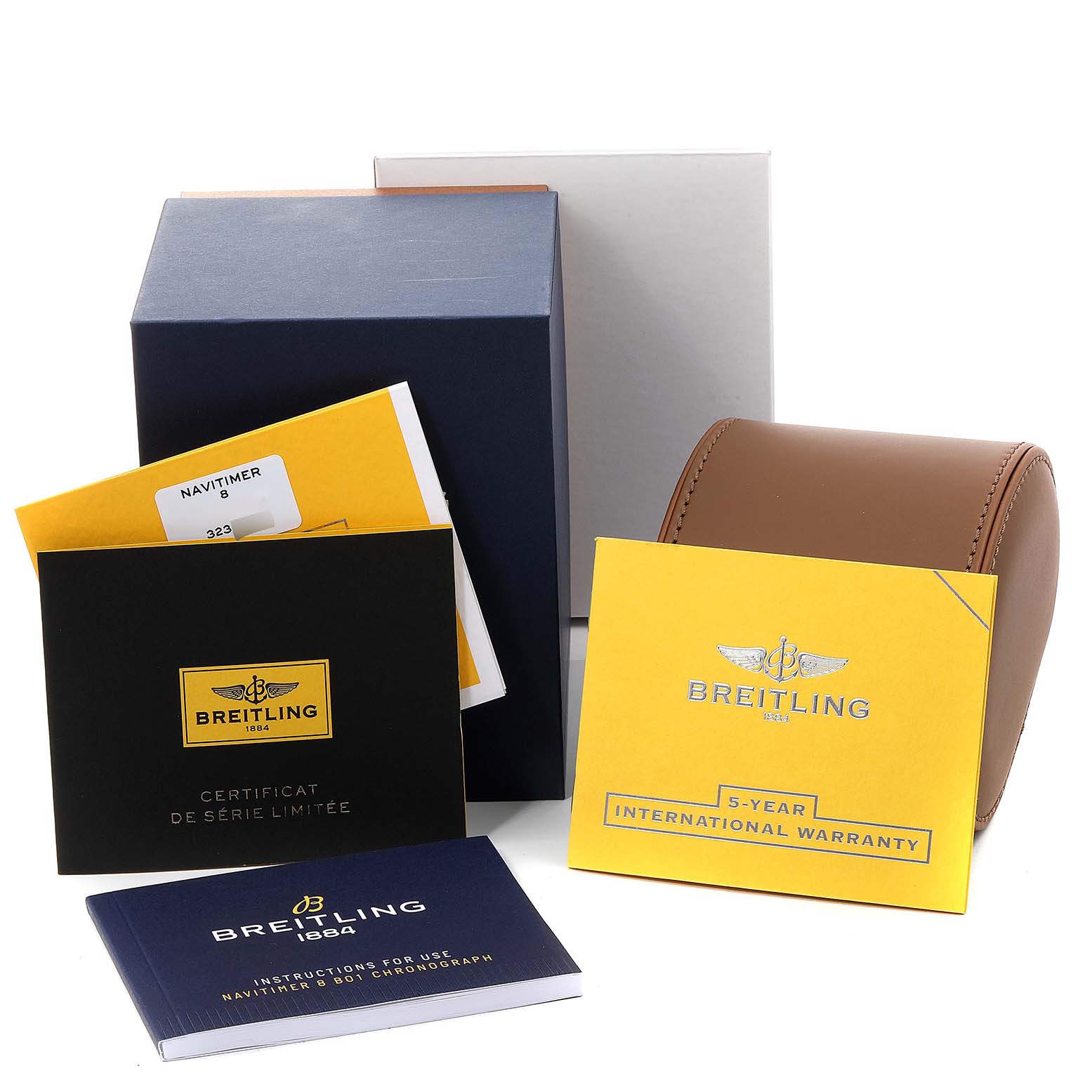 This image shows the packaging, warranty cards, manuals, and a travel case for a Breitling Navitimer watch.