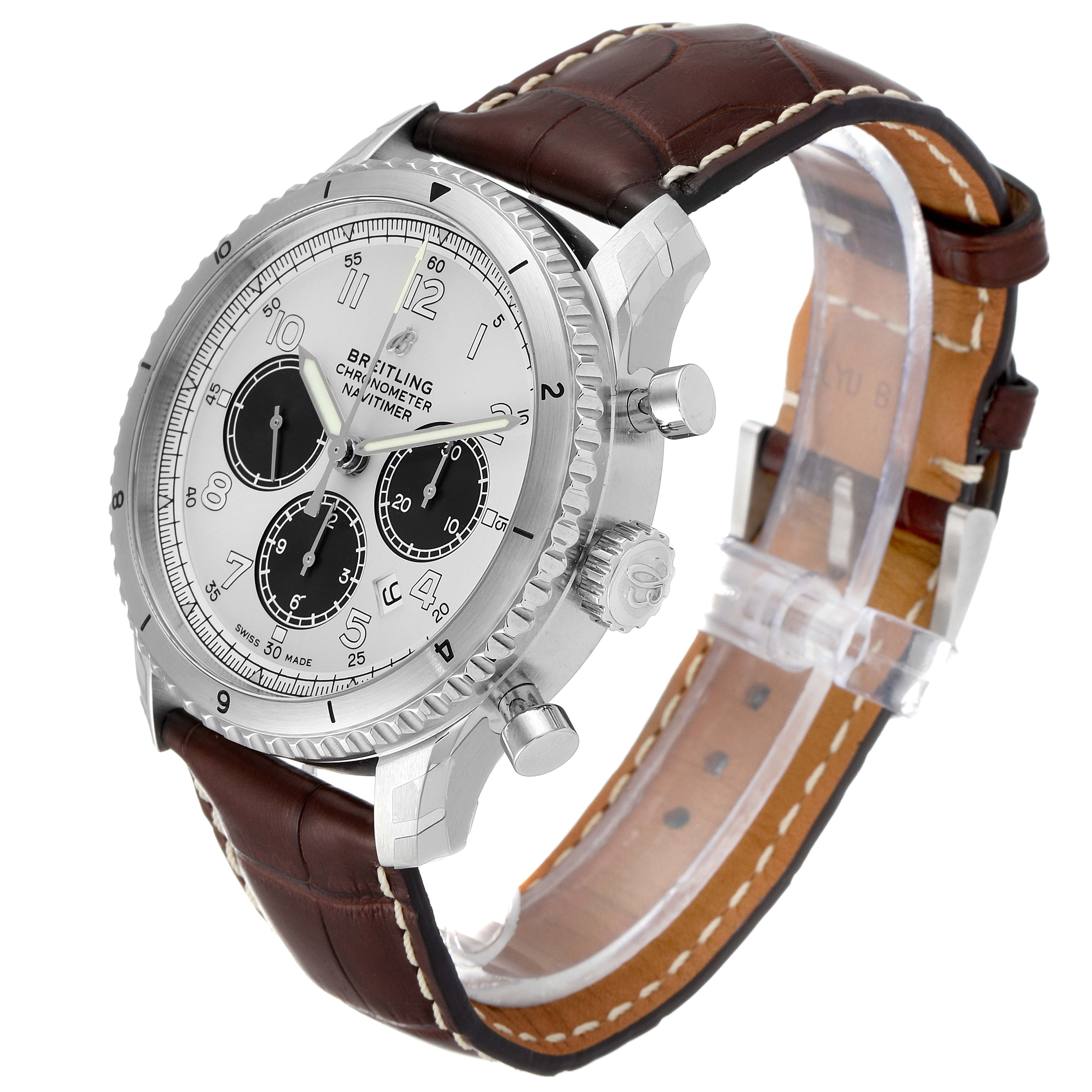 The Breitling Navitimer watch is shown at a three-quarter front angle, highlighting its face, bezel, pushers, crown, and leather strap.