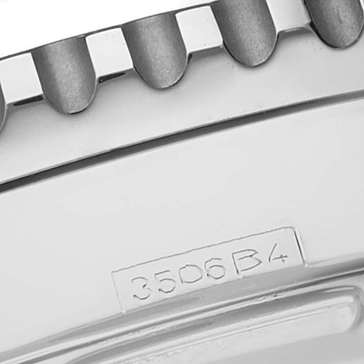 The image shows a close-up of the bezel and part of the case back of a Breitling Navitimer A23322 Men
s Stainless Steel Black Dial A23322 Men
s Stainless Steel Black Dial watch.