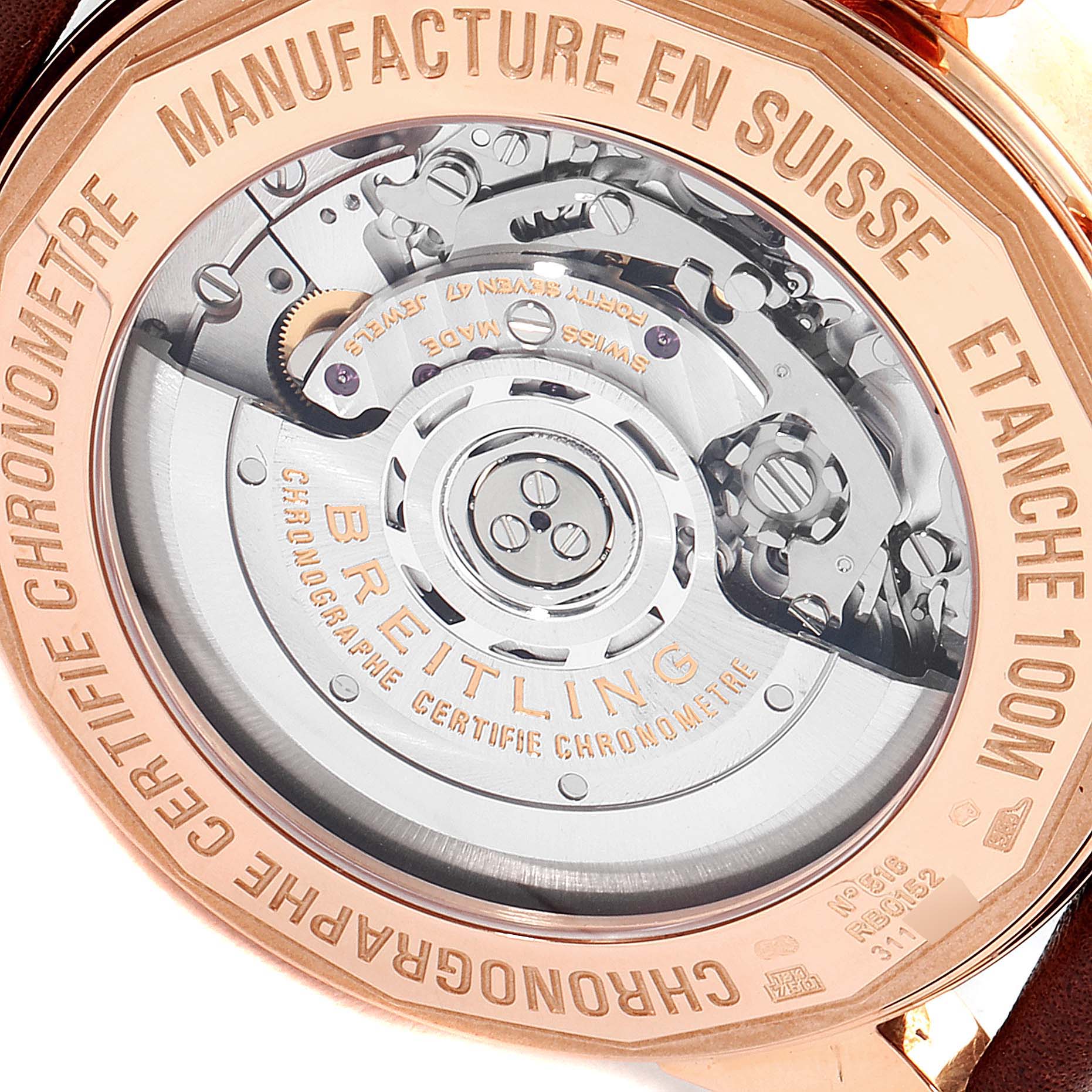 The image shows the back view of a Breitling Transocean RB0152 Men's Rose Gold Silver Dial RB0152 Men's Rose Gold Silver Dial watch, highlighting its inner mechanical movement.