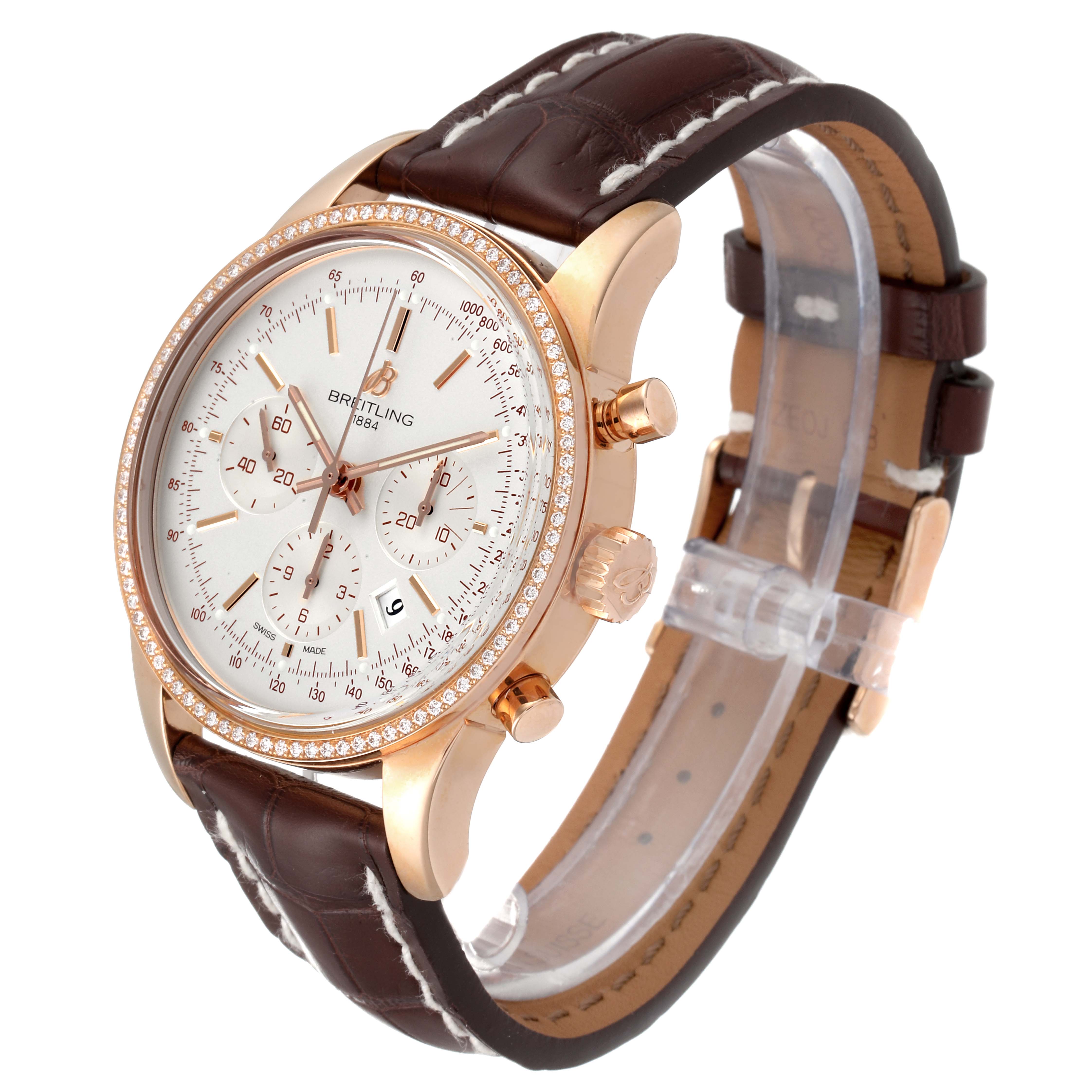 The Breitling Transocean RB0152 Men's Rose Gold Silver Dial RB0152 Men's Rose Gold Silver Dial watch is shown at a front-angle, highlighting its face, bezel, pushers, and leather strap.