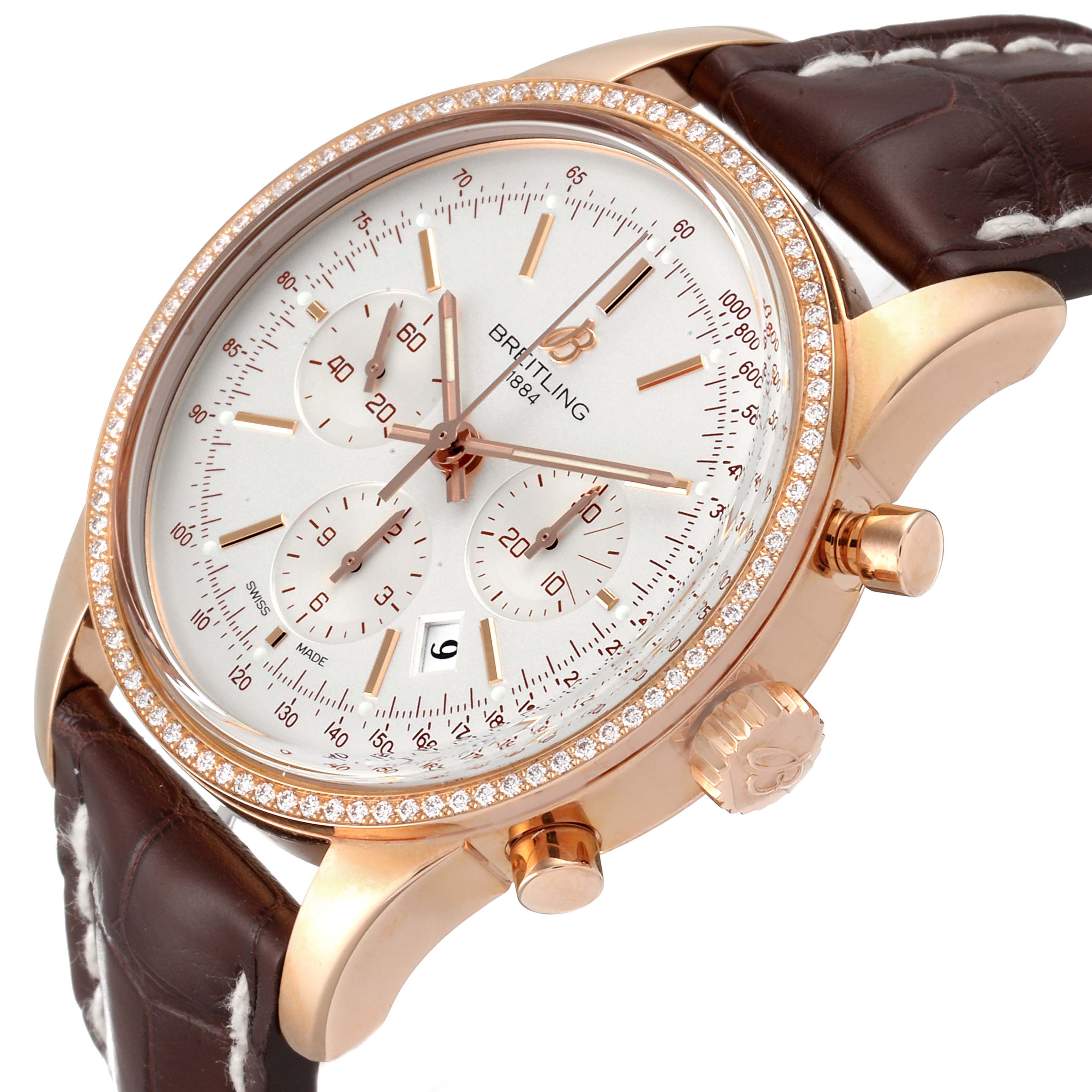 The image shows a side angle of the Breitling Transocean RB0152 Men's Rose Gold Silver Dial RB0152 Men's Rose Gold Silver Dial watch, highlighting the face, dial, bezel, chronograph buttons, and leather strap.