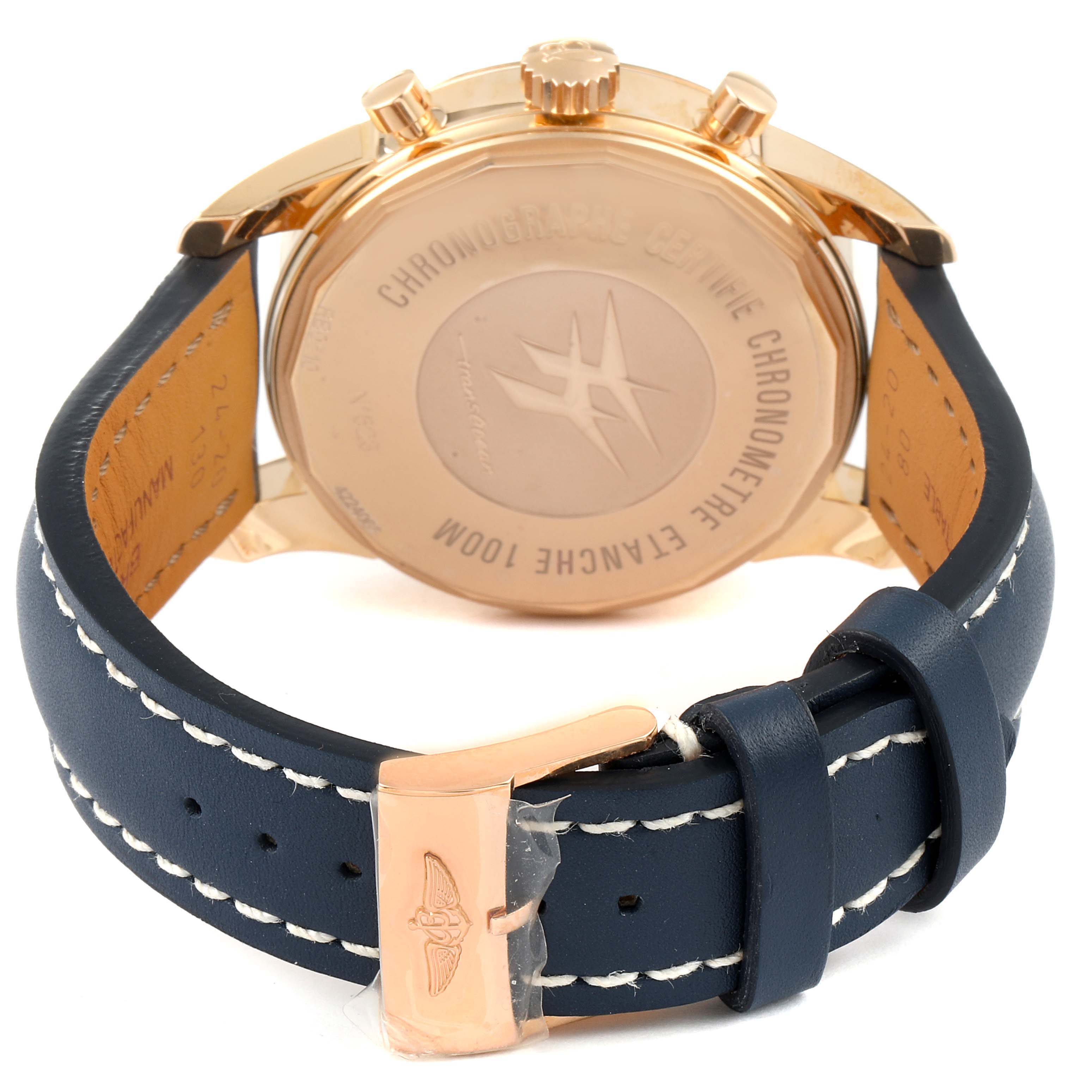 This image shows the back of a Breitling Transocean RB0510U4-BB63BKLD Men's Rose Gold White Dial RB0510U4-BB63BKLD Men's Rose Gold White Dial watch, including the case back and part of the navy blue leather strap with a gold buckle.